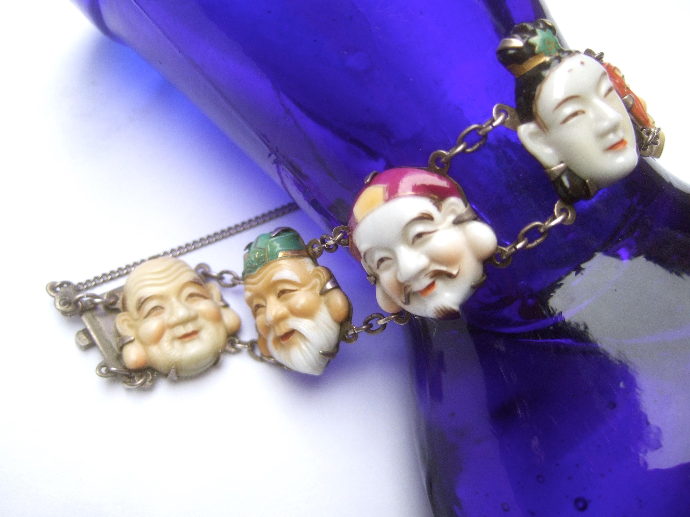 Seven Immortal Lucky Gods of Japan Sterling & Porcelain Figural Bracelet c 1950s In Good Condition For Sale In University City, MO