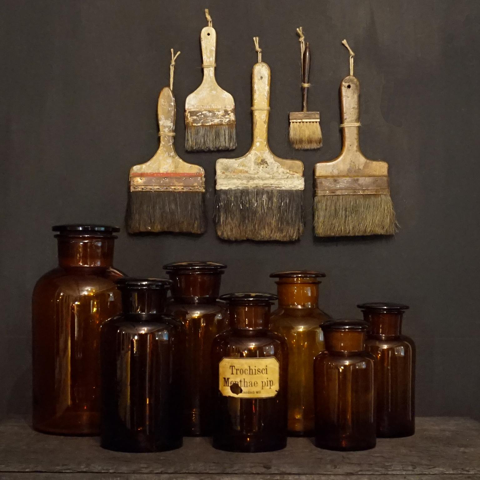 A decorative collection of seven extra large German 1930s-1940s apothecary jars in blown and pressed amber glass with pressed and blown glass lids. 
Once used for chemistry and pharmaceutical stuff, now very pretty as decoration set.
Not jet antique