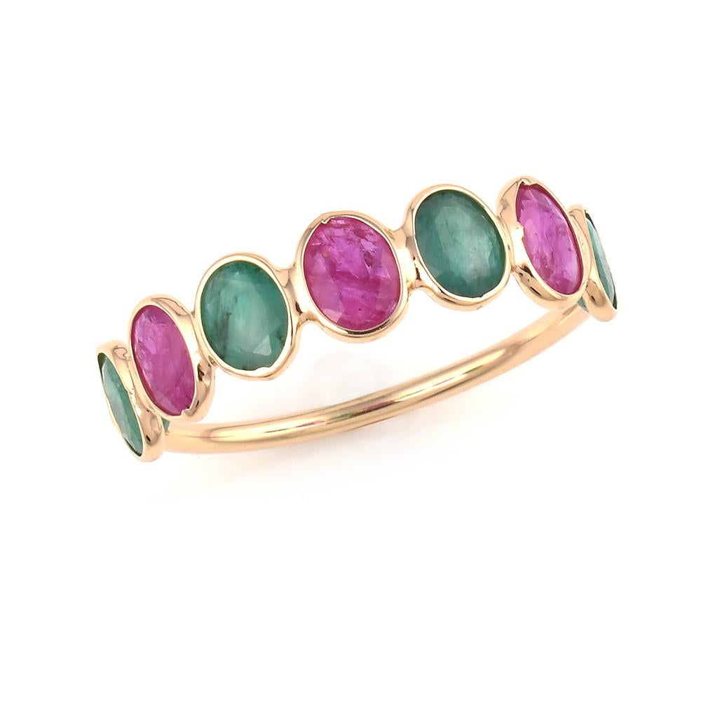 A 4 x 5MM Oval Ruby and Emerald Ring Band, where the stones weigh 2.30 carats. The ring is made in 18K Yellow Gold. The total weight is 1.54 grams. Ring Size US 7.25.
