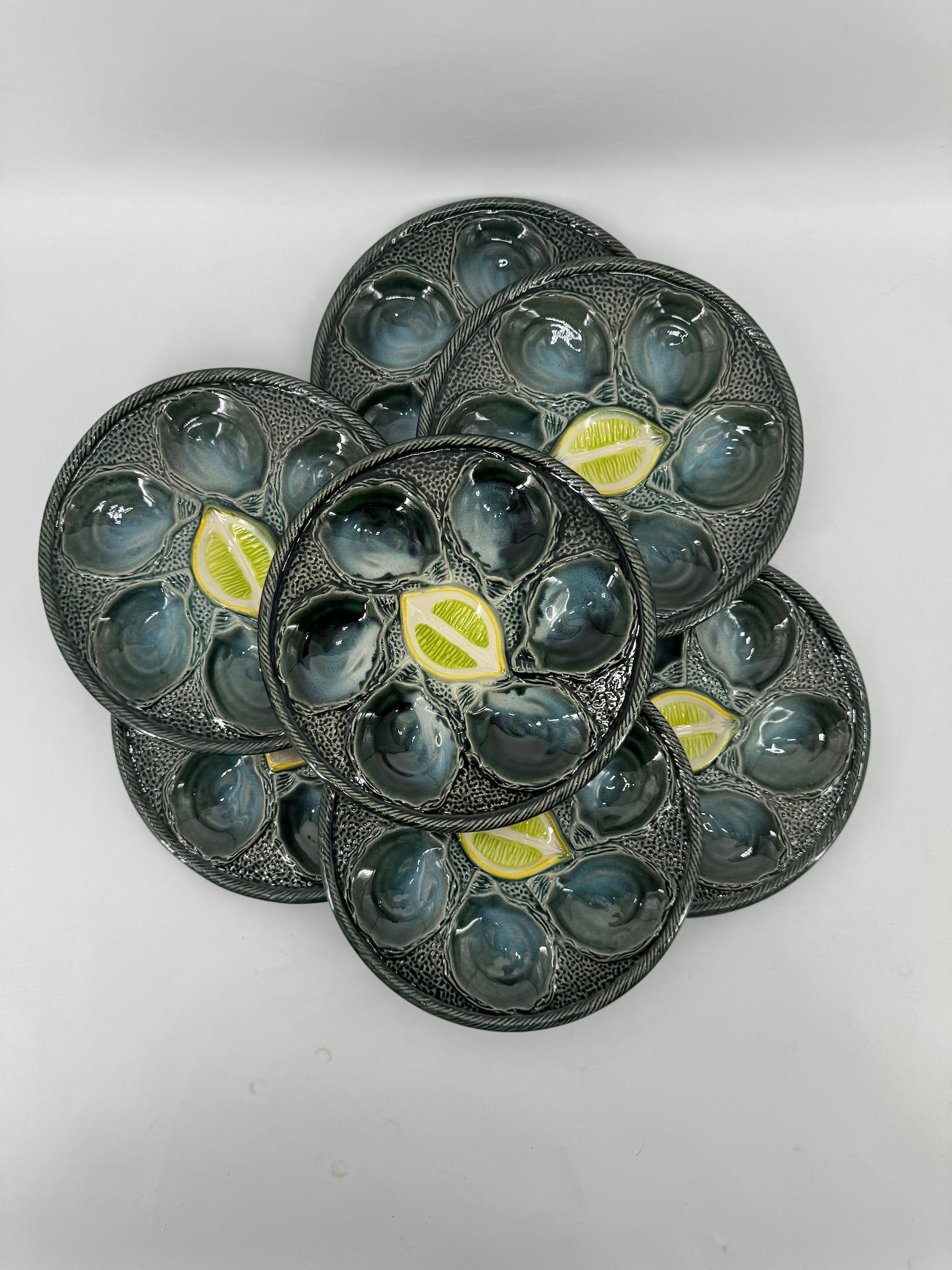 Seven Oyster Plates and one Oyster Dish in Saint Clément Barbotine midcentury

A very fine piece from the Manufacture Saint Clément for presenting oysters, shellfish or other seafood.
The colour is a rare cameo of green and intense bluish green,