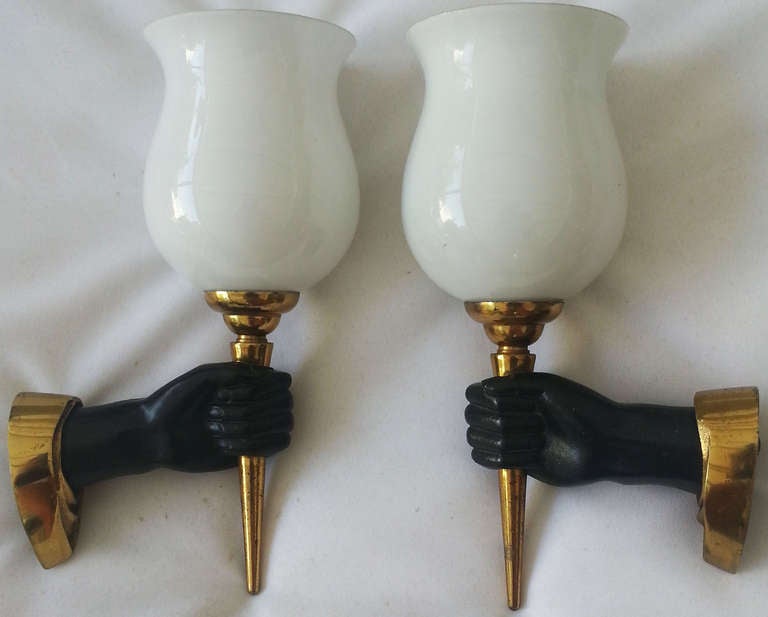 Exceptional pairs of Arbus bronze sconces  , hands holding a torch. Size of the back plate 3.5