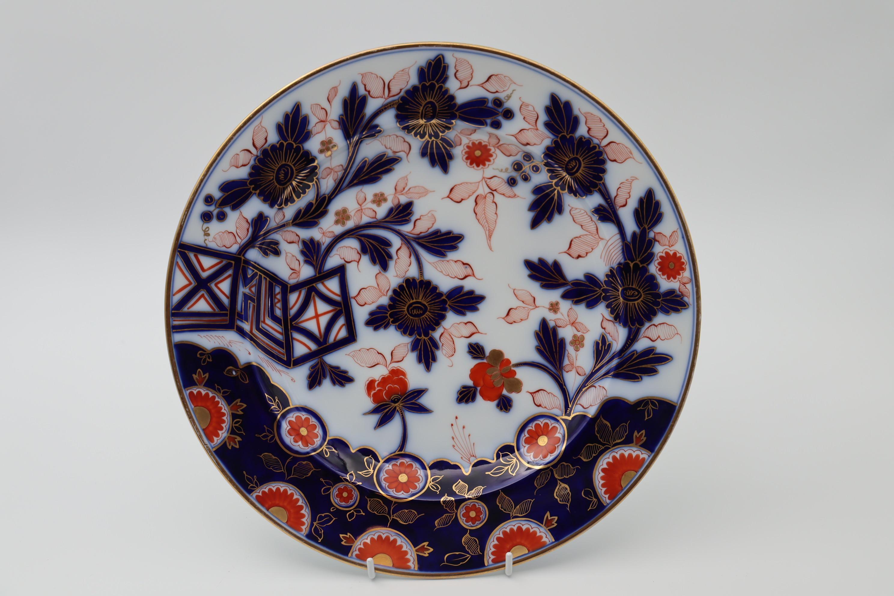 This seven piece dessert set by Fischer and Mieg of Bohemia consists of a large bowl and six plates. They are decorated with a hand painted and gilded Imari pattern using the traditional colours of underglaze blue, iron red and gold. The bowl