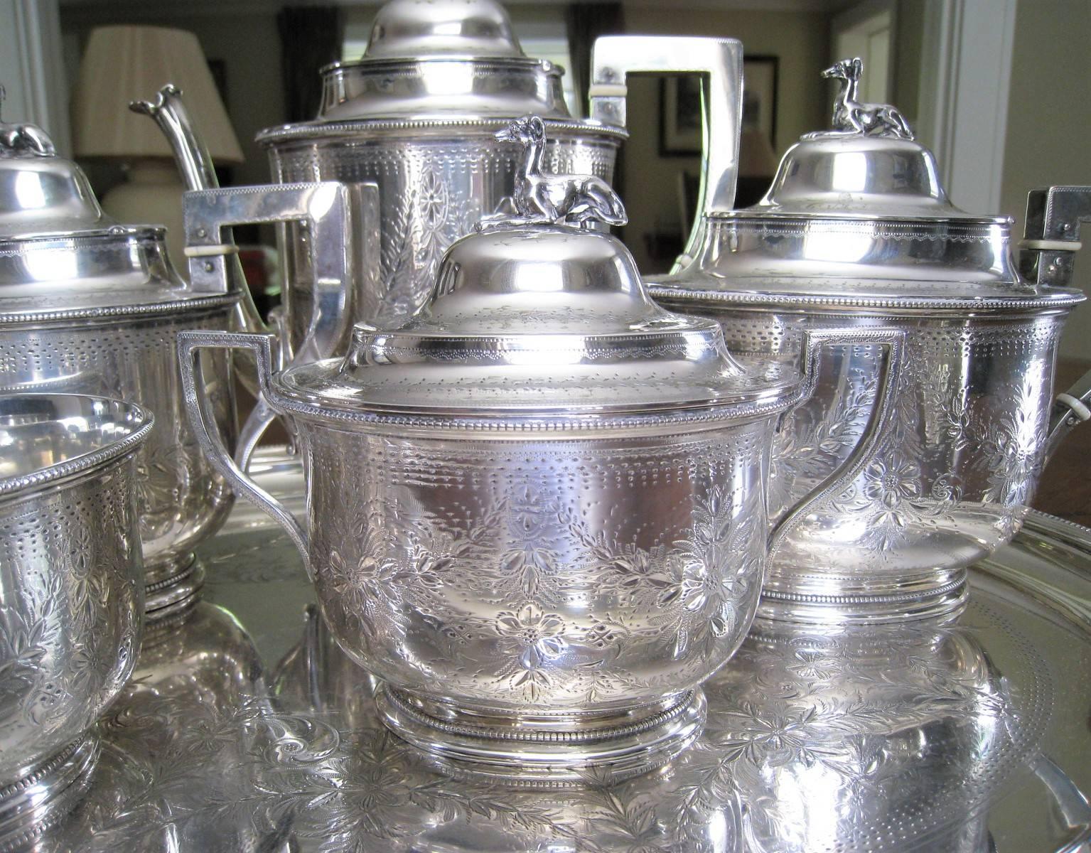 Beautiful antique seven-piece coin silver tea set made by Augustus Rogers & John Wendt, circa 1850 along with a matching silver plated tray. The eight-piece set consists of seven coin silver pieces; coffee pot, two tea pots, covered sugar, creamer,