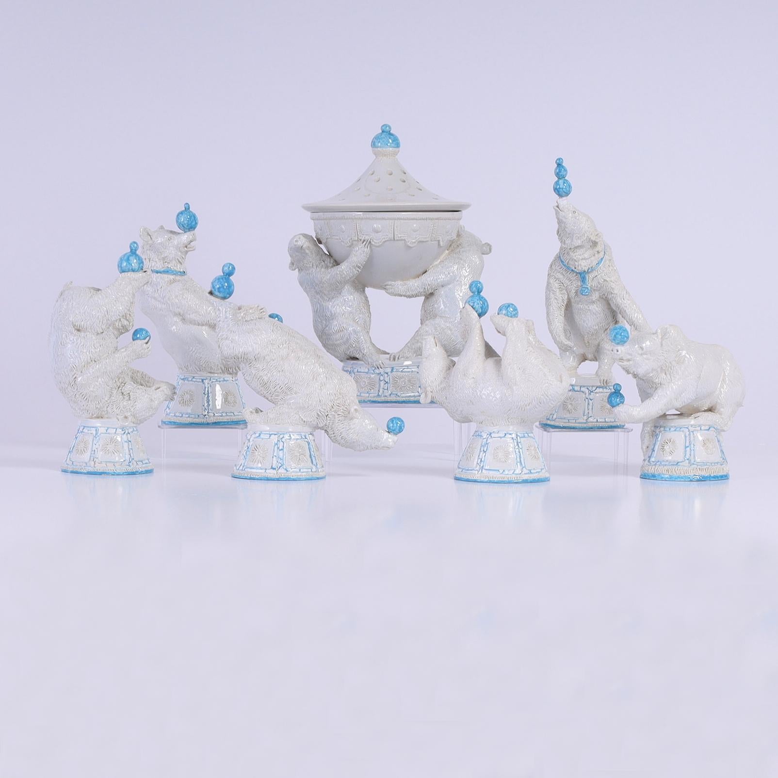Charming seven piece set of porcelain circus bears including six bears balancing blue balls in unlikely positions and two holding a lidded urn. Created by famed Italian Artist Andrea Spadini and signed on the bottoms 