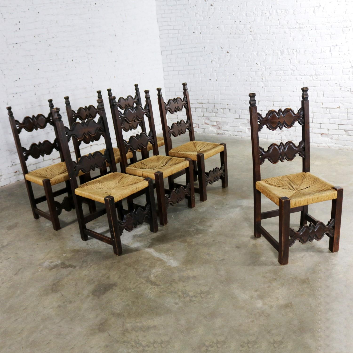 Amazing set of seven Spanish Revival style dining chairs with original rush seats by Artes De Mexico Internacionales, SA. Most of the seven chairs retain their original label. They are in wonderful vintage condition with lots of beautiful age patina
