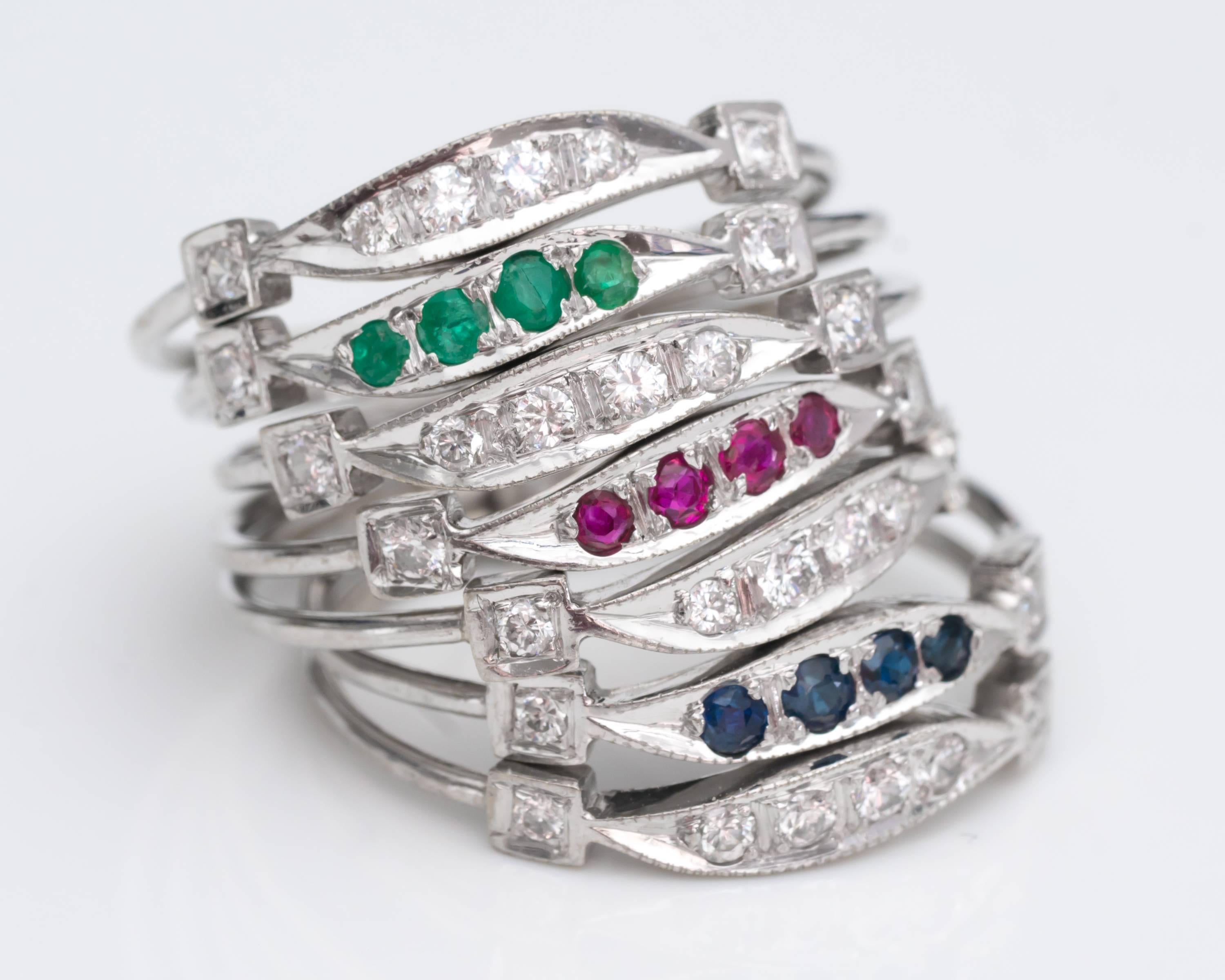 Gemstone Ring Stack, 7 Rings - 14K White Gold, Diamonds, Emeralds, Rubies, Sapphires

Features 7 Rings banded together in the back to create a single stack. 
Diamonds, Sapphires, Rubies and Emeralds are set in Shining, Bright, 14K White Gold.
4 of