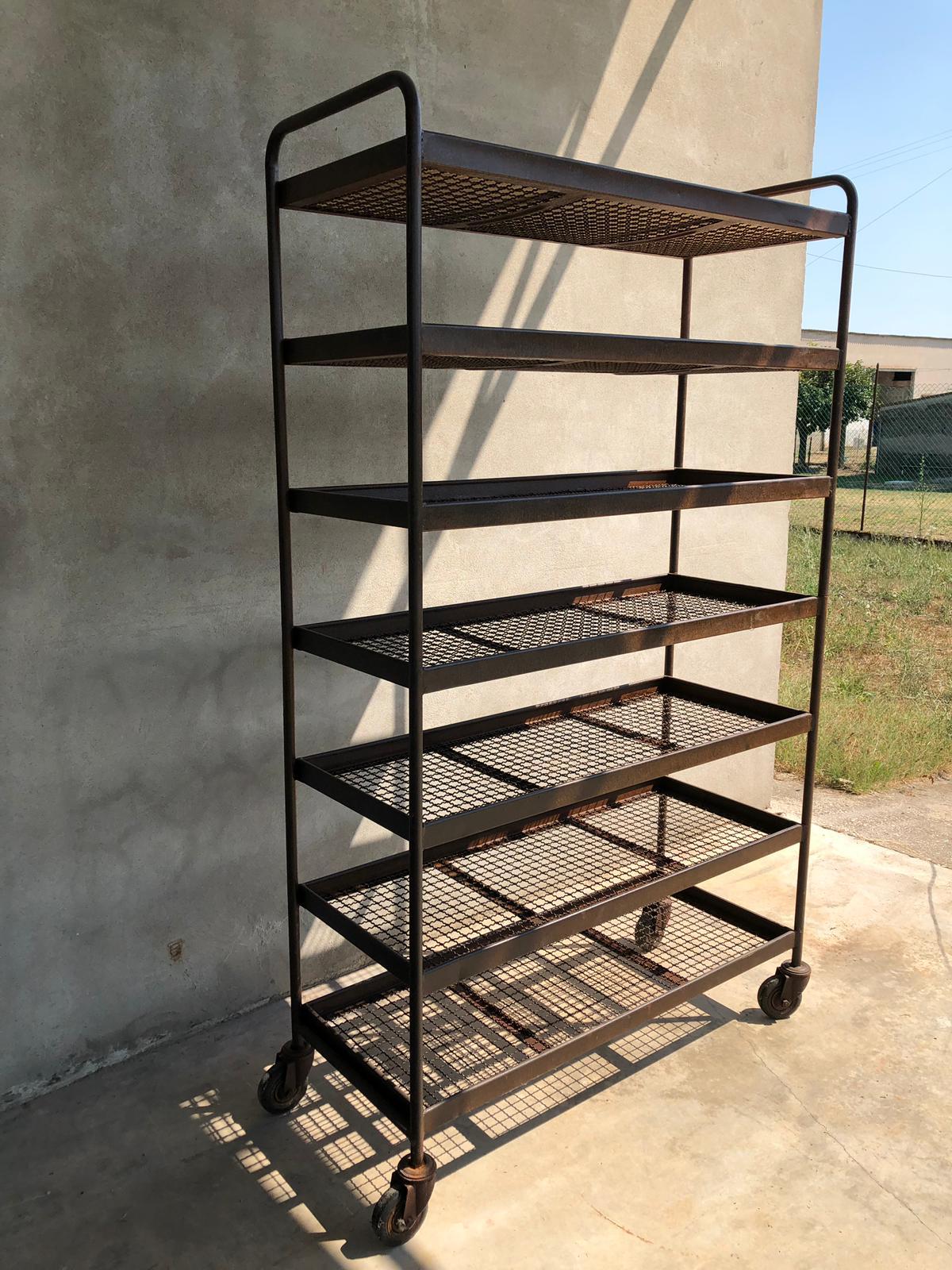 Seven shelves industrial iron wheeled trolleys. Size: H 215 cm, D 51 cm, W 120 cm. Quantity available n 7.

Industrial iron wheeled trays with or without wooden shelves. From Italy from midcentury period.
Trolleys are made of industrial tubular iron
