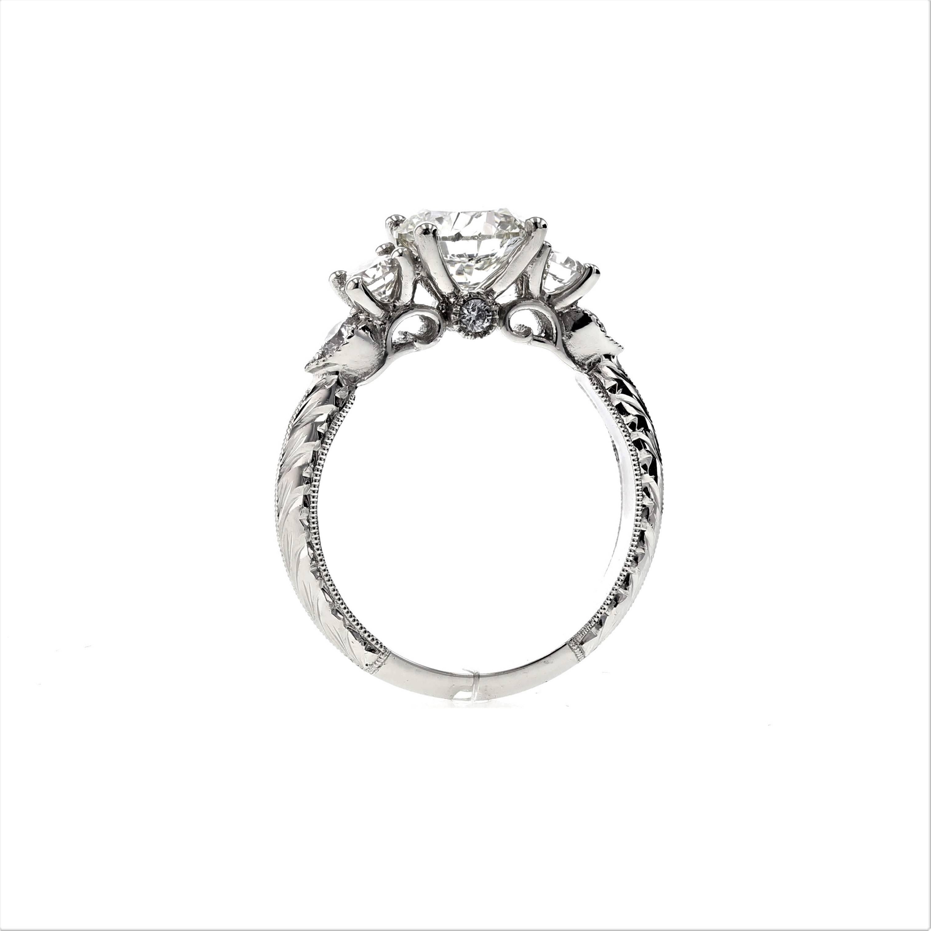 This stunning custom engagement ring incorporates seven diamonds and an intricate setting in platinum. Using embellishments such as engraving, bezels and a knife edge, this ring is a masterpiece and timeless in its beauty. It’s one of our favorites.