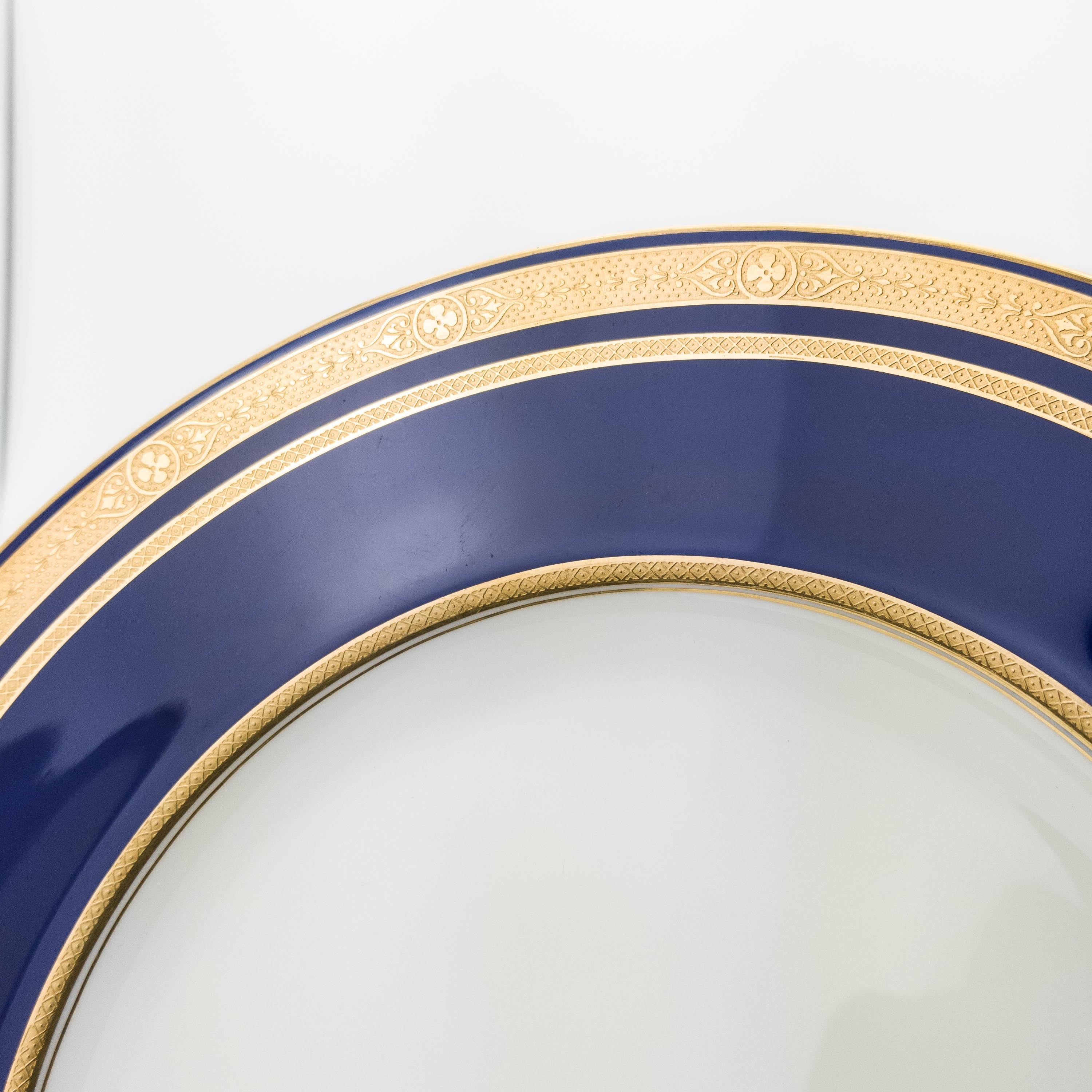 The magic name for custom ordered porcelains during the Gilded Age. This Classic and elegant pattern features a rich cobalt blue collar with an interesting gilt encrusted design. Clear centers and crisp white porcelain will make these a favorite for