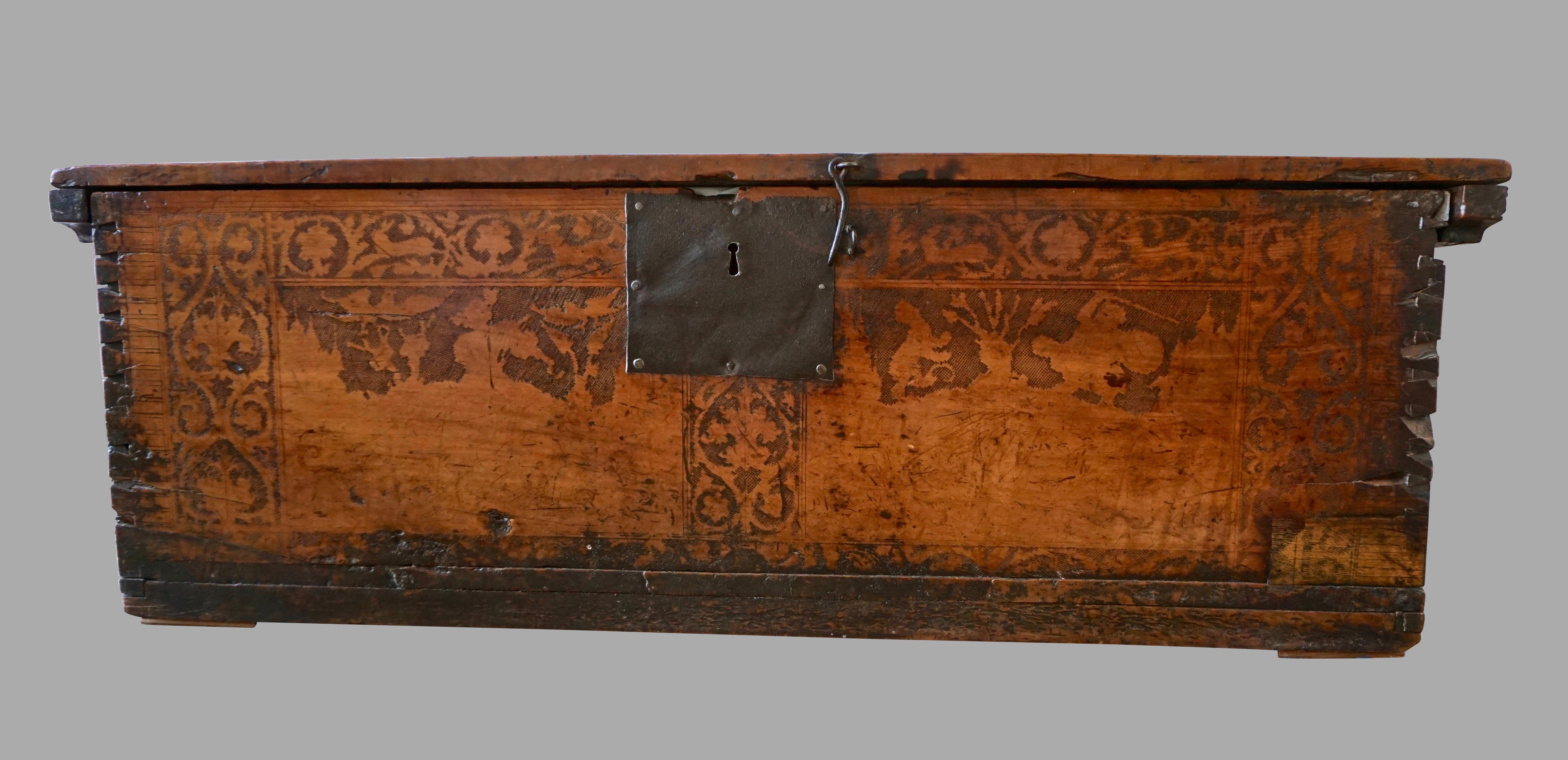 An interesting and highly decorative Italian walnut coffer with dovetailed corners, the front and inside of the top decorated with various incised themes, including a coat of arms, flowers and animals. Fine old patina and color. Provenance: