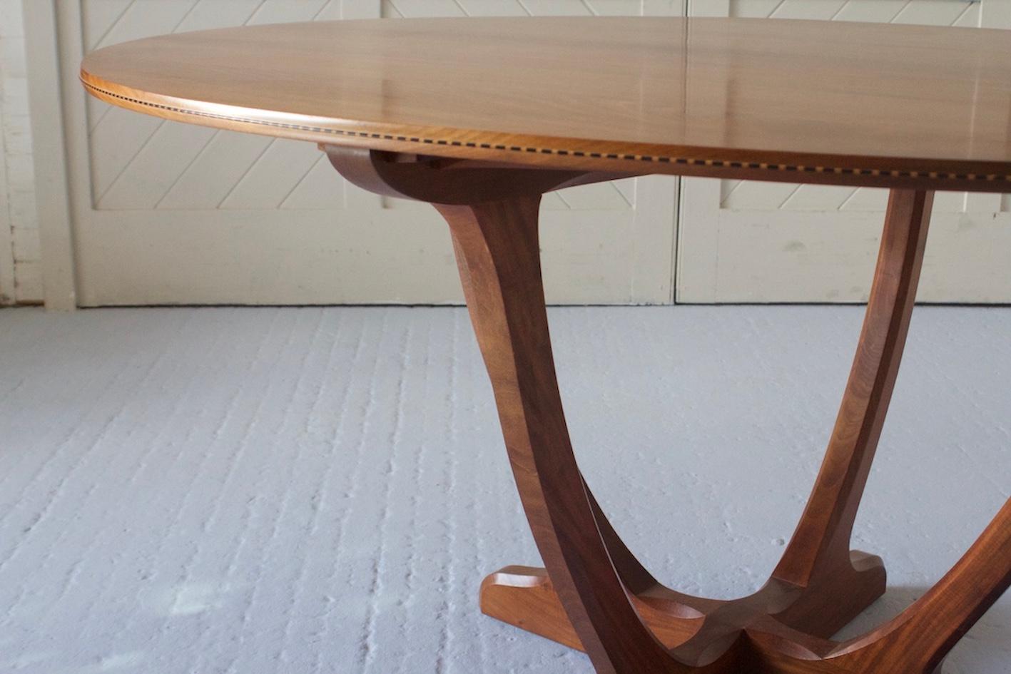 This is a beautifully crafted oval dining table made in the finest Cuban Mahogany with a chequer inlay detailing around the perimeter of the table. The feet have been inset to the underside with boiled holly wood. This design is in order to prevent