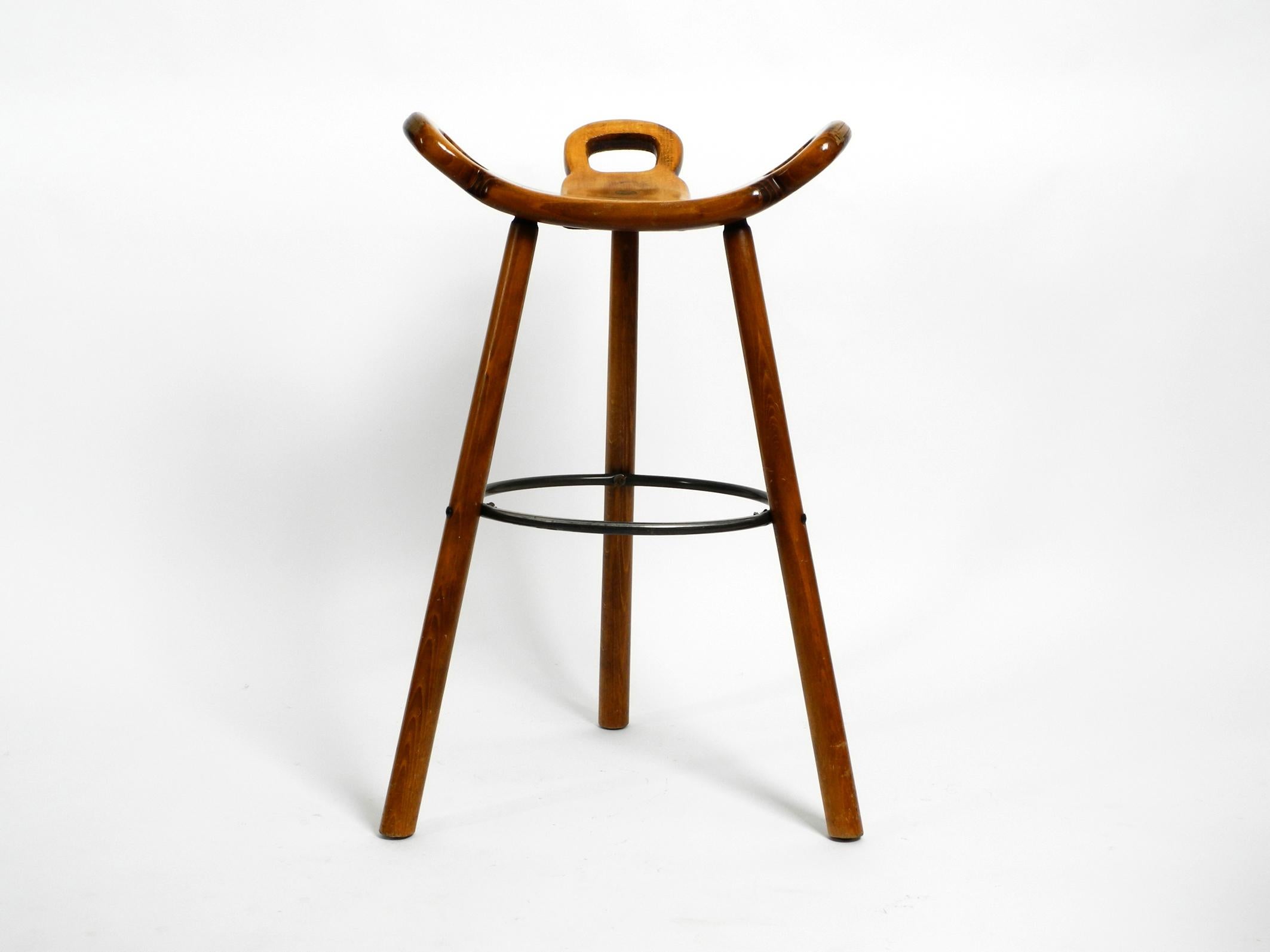 Seventies spanish Marbella bar stool by Sergio Rodrigues for Confonorm.
The design classic among the bar stools.
Beautiful solid three-legged bar stool made of solid wood.
Fantastic condition without damages. Not wobbly, all legs are firm and