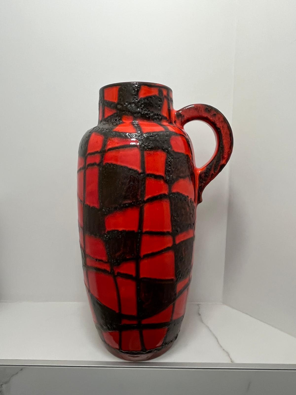 Amazing spider web vase in a vibrant orange with black fat lava. 
These vases are very sought after and in this size difficult to find. 
