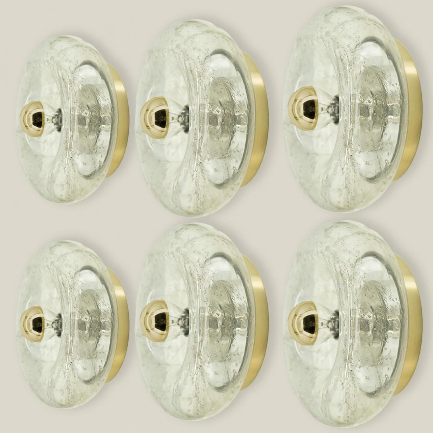 Beautiful donut glass wall light/flush mount by Doria Leuchten, Germany 1970s. The glass is mounted on a brass back plate.

Can be used as a wall light or flush mount.

Please notice the price is for one piece, we have several pieces