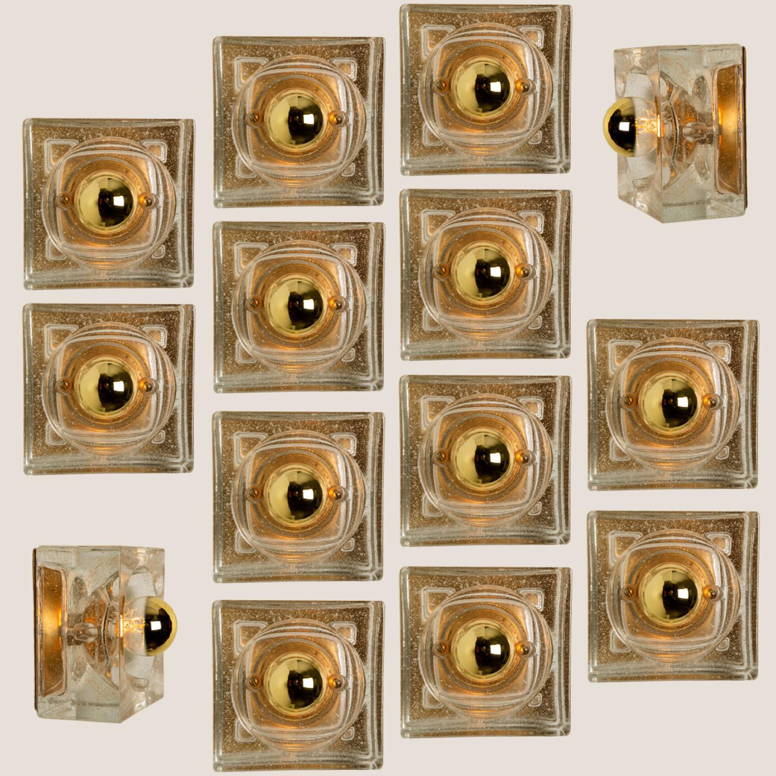 These lights are made from thick blown glass on a square gold colored backplate. The glass causes a nice lighting effect on the ceiling, table or wall. Each lamp has one E14 fitting (Max 25 Watt)

Can work for impressive wall, table or ceiling