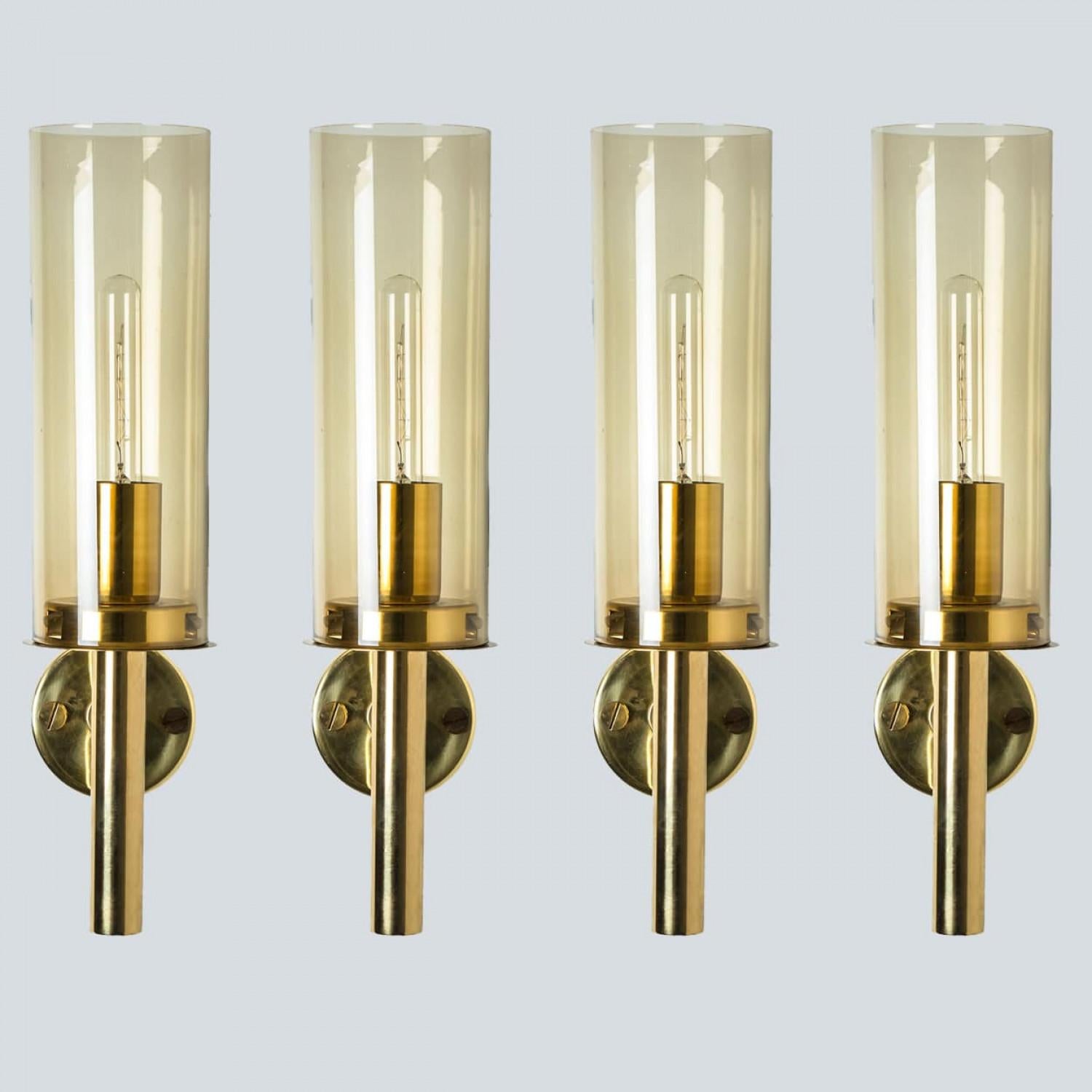 These stunning brass wall lights with clear glass are produced in the 1960s in the style of Hans-Agne Jakobsson. Design executed with a taste for excellence in craftsmanship.

Dimensions:
Height:13.77