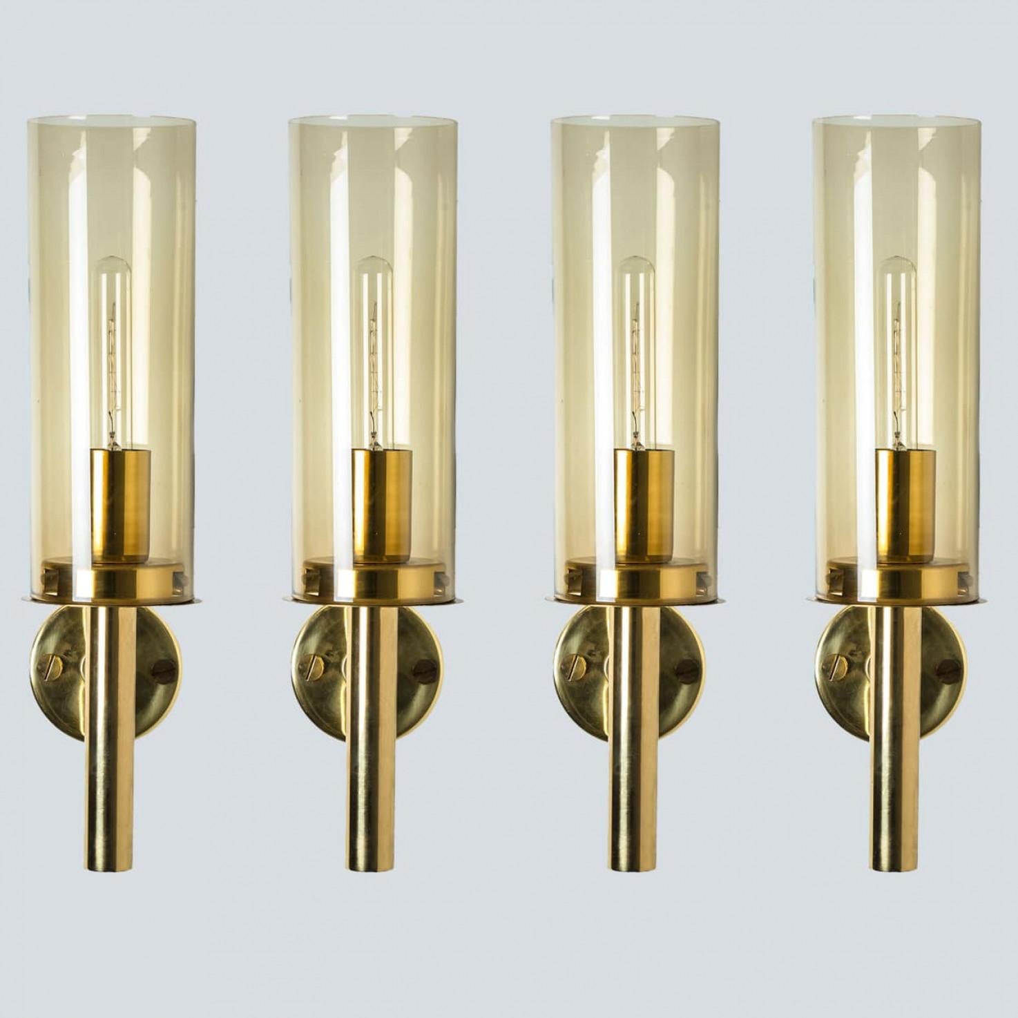 These stunning brass wall lights with clear glass are produced in the 1960s in the style of Hans-Agne Jakobsson. Design executed with a taste for excellence in craftsmanship.

Dimensions:
Height:13.77