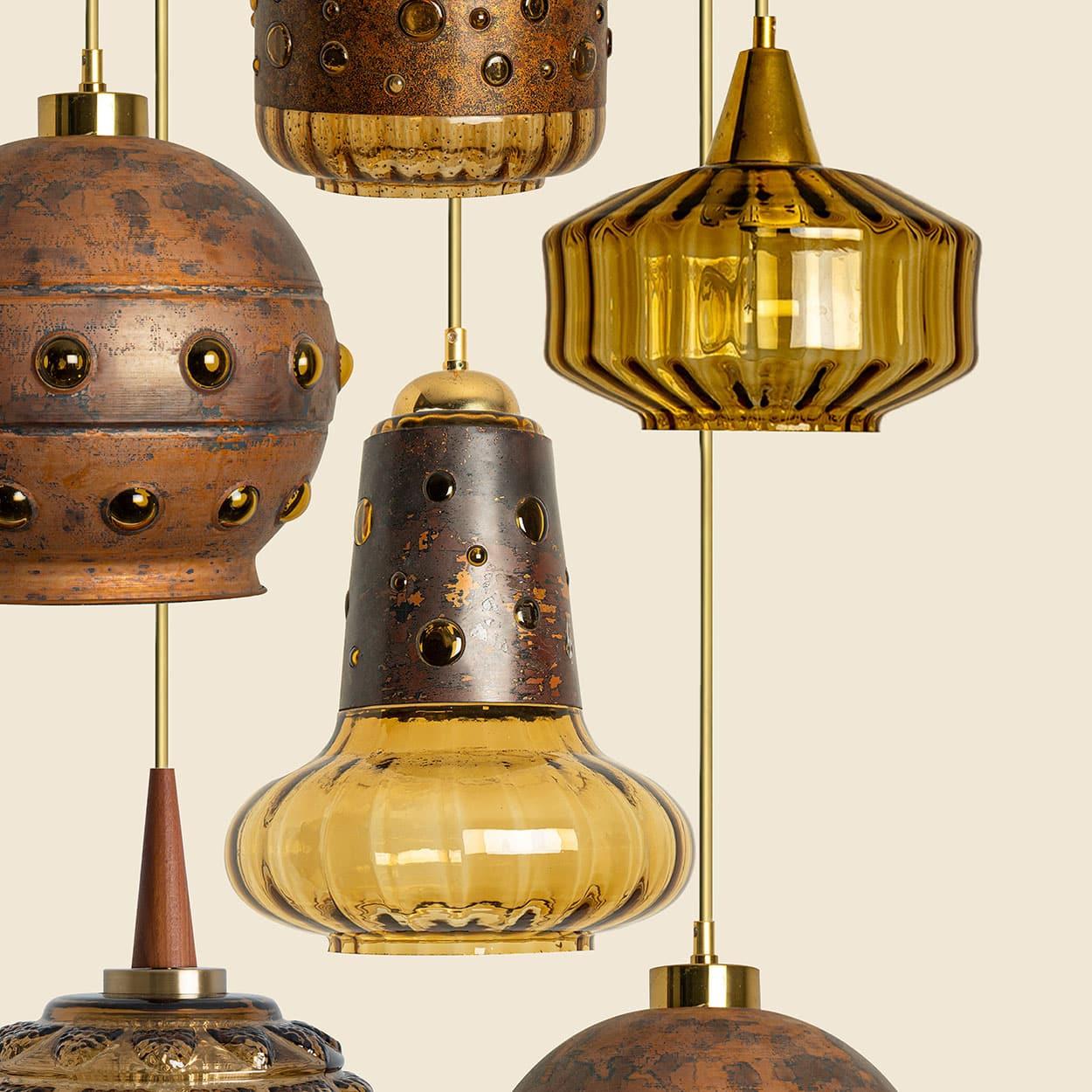 Several Brutalist pendants in the style of Nanny Still McKinney and from Fagerlund, Netherlands and Denmark 1960s.

This acid-treated copper pendant with an amber optical striped blown glass main-shade creates a stunning illumination. A real