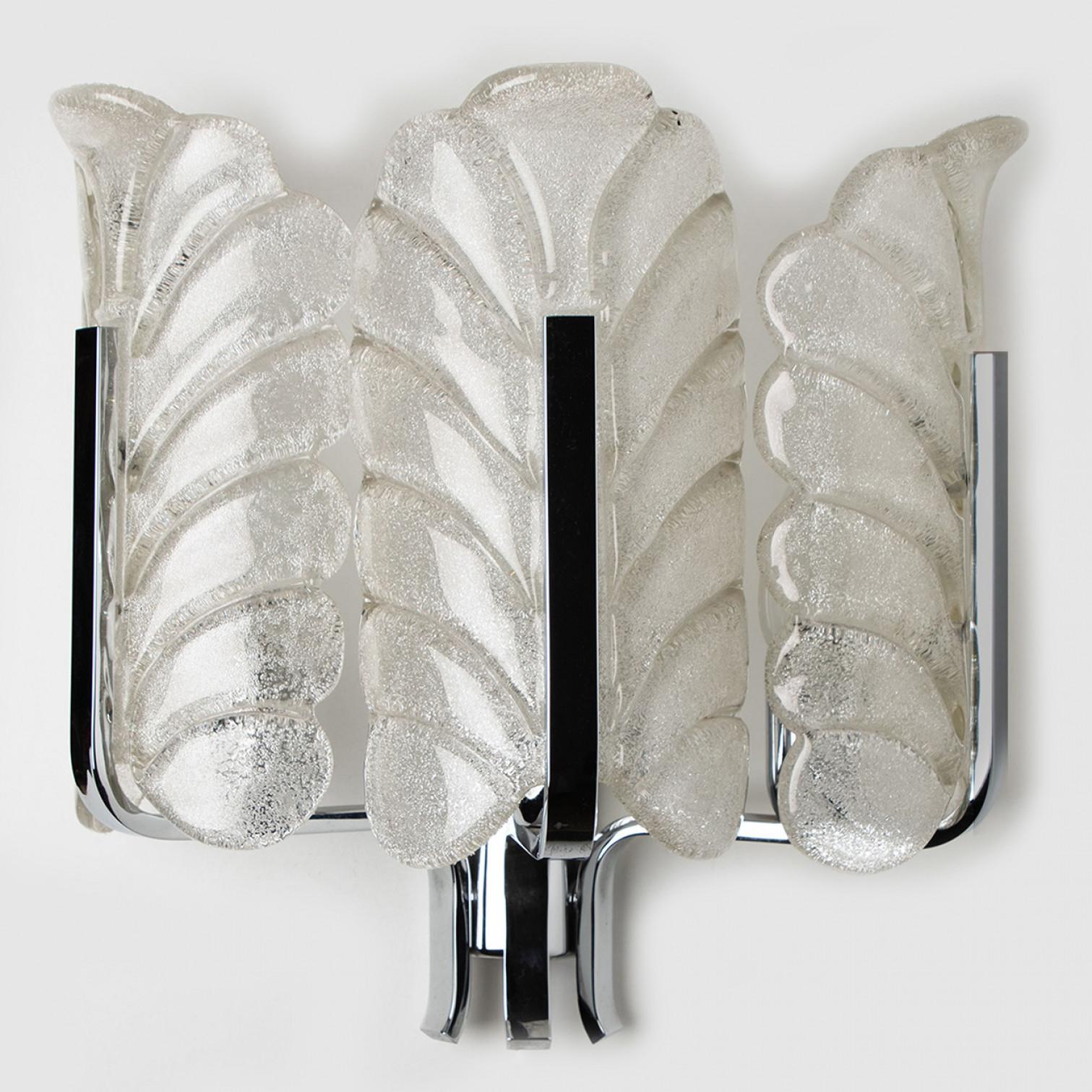 This beautiful wall light with three glass shades and chrome base was produced in the 1960s by the iconic firm of Orrefors and designed by Carl Fagerlund. Beautifully carved clear frosted glass shades in a leaf design on chrome fittings. The leaves