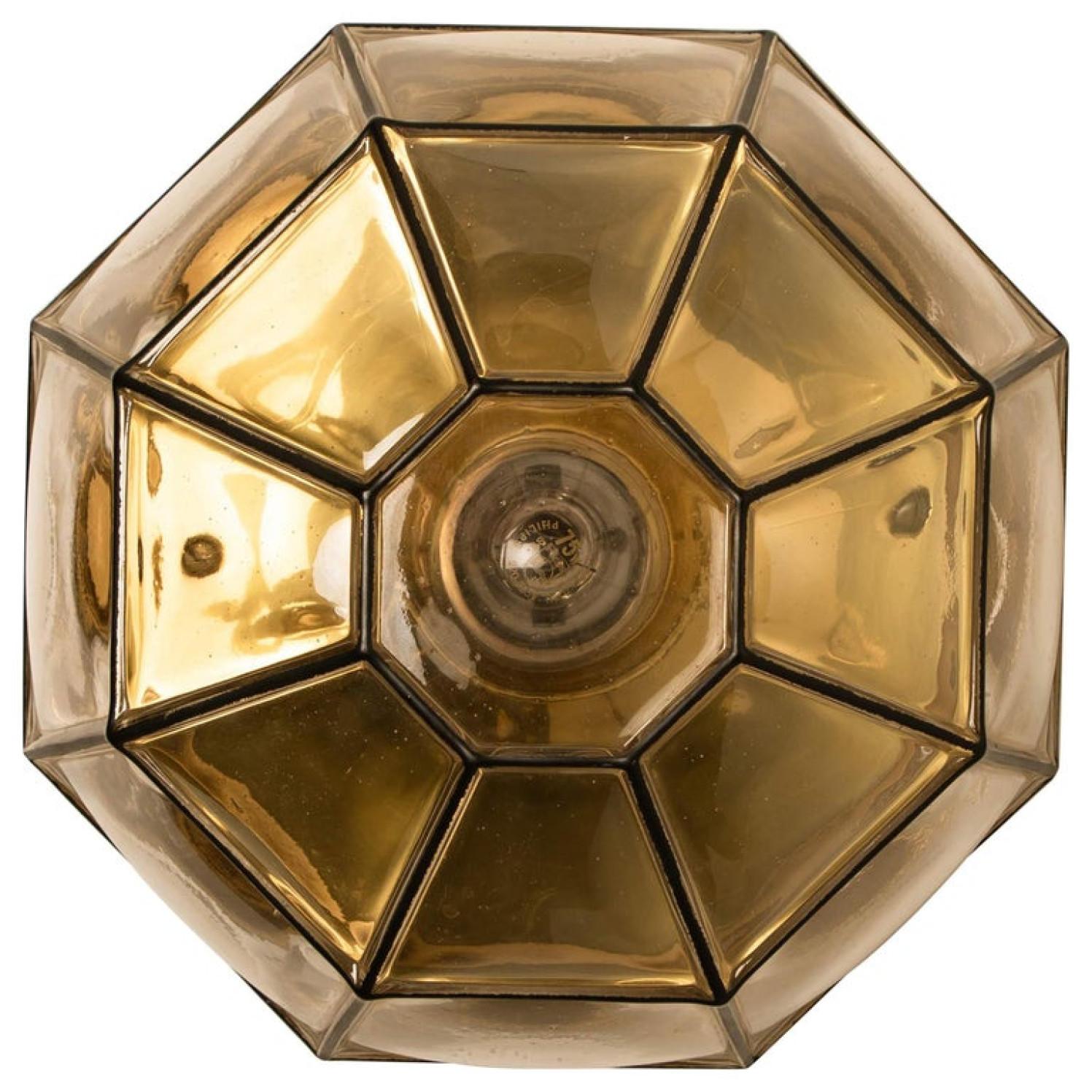 This beautiful and unique octagonal glass light flush mount or wall light was manufactured by Glashütte Limburg in Germany during the 1960s (late 1960s or early 1970s). Nice craftsmanship. Elaborate clear bubble glass which bulges slightly out of
