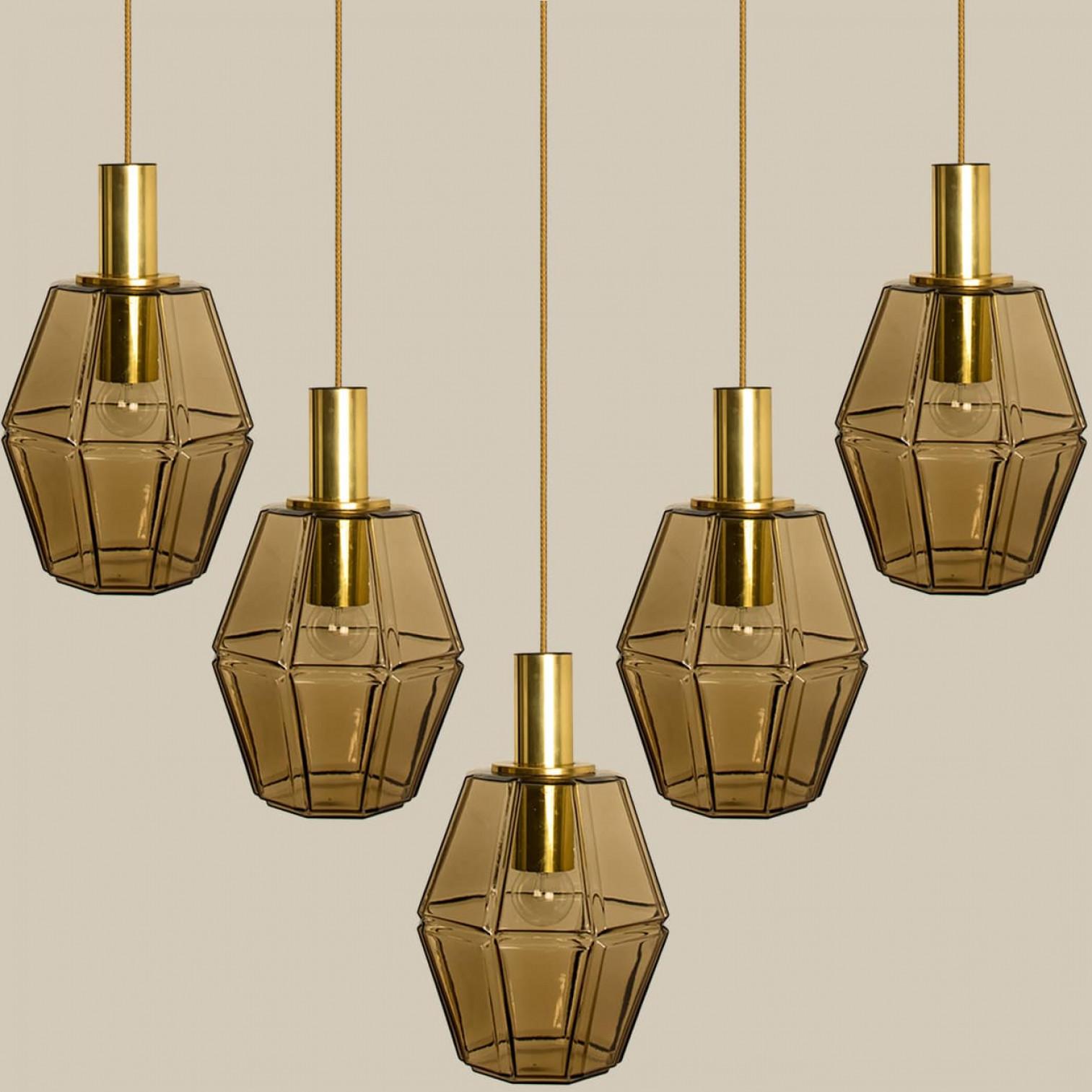 Several geometric brass and glass pendant lights by Limburg, 1970s.

Beautiful minimalistic light fixture, clean lined and timeless design.

Illuminates beautifully.

Please notice the price is for one piece, we have several pieces available.

Heavy