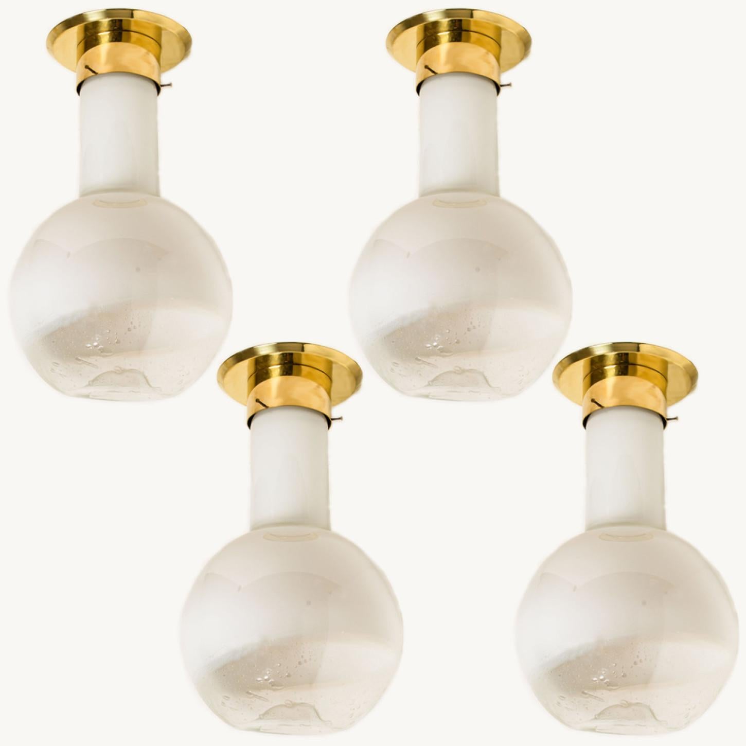 These beautiful large glass ceiling lamps with brass details were manufactured by Harrachov in the Czech Republic around 1970.

The lamps have a beautiful shape, half cylinder and half round. This creates an elegant appearance, that is beautifully