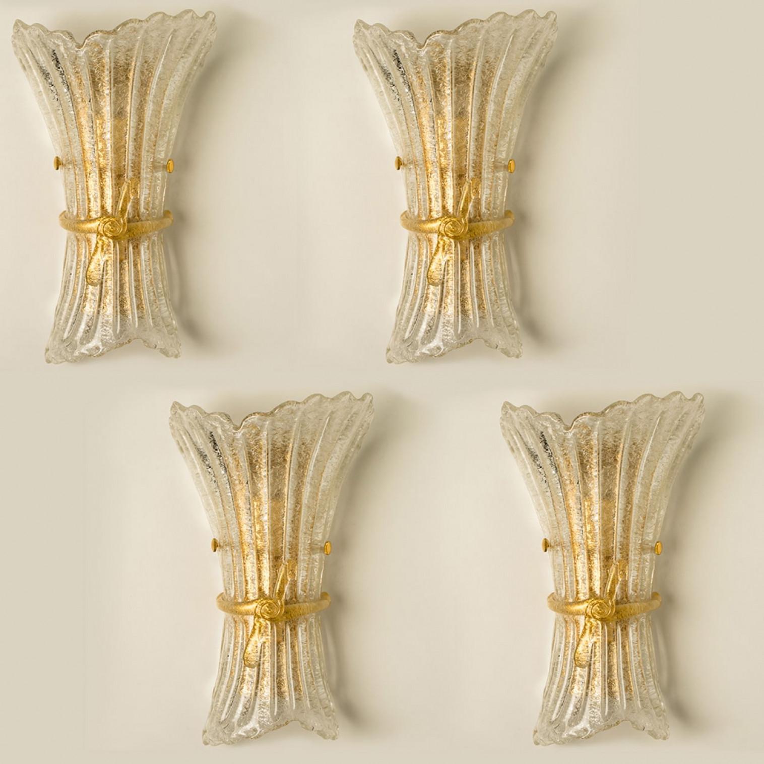 Several elegant hand blown Murano glass wall sconces. The lights come from Murano, Italy. Mounted on an brass frame. The Murano glass refracts the light beautifully. The wall lights fill the room with a soft, warm and welcoming glow.

Cleaned and