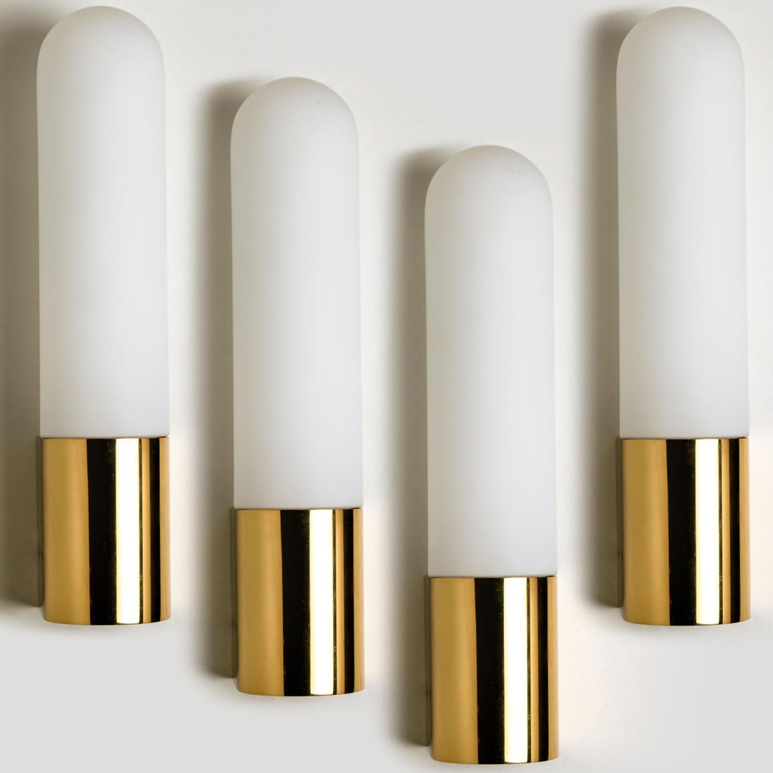 Heavy quality glass lamps with brass base. Beautiful white, opaque glass. Manufactured by the company Glasshütte Limburg, in Germany, Europe around 1970.

This wall light gives a warm light that suits any space.

Please notice the price is for 1