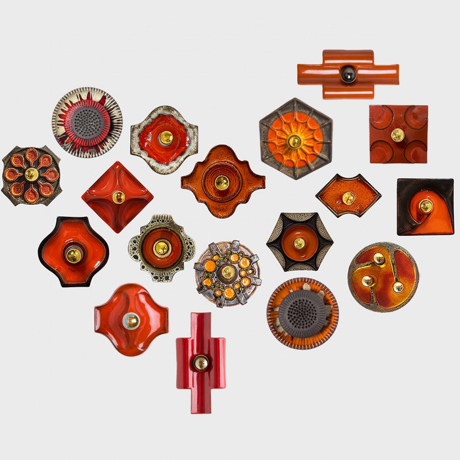 We have a whole range of mid-century West-Germany wall lights all in  orange and brown tones
They are from around 1970 and typical for West-Germany ceramics during that time.

They are a bit different is size, but approximately around 10.65