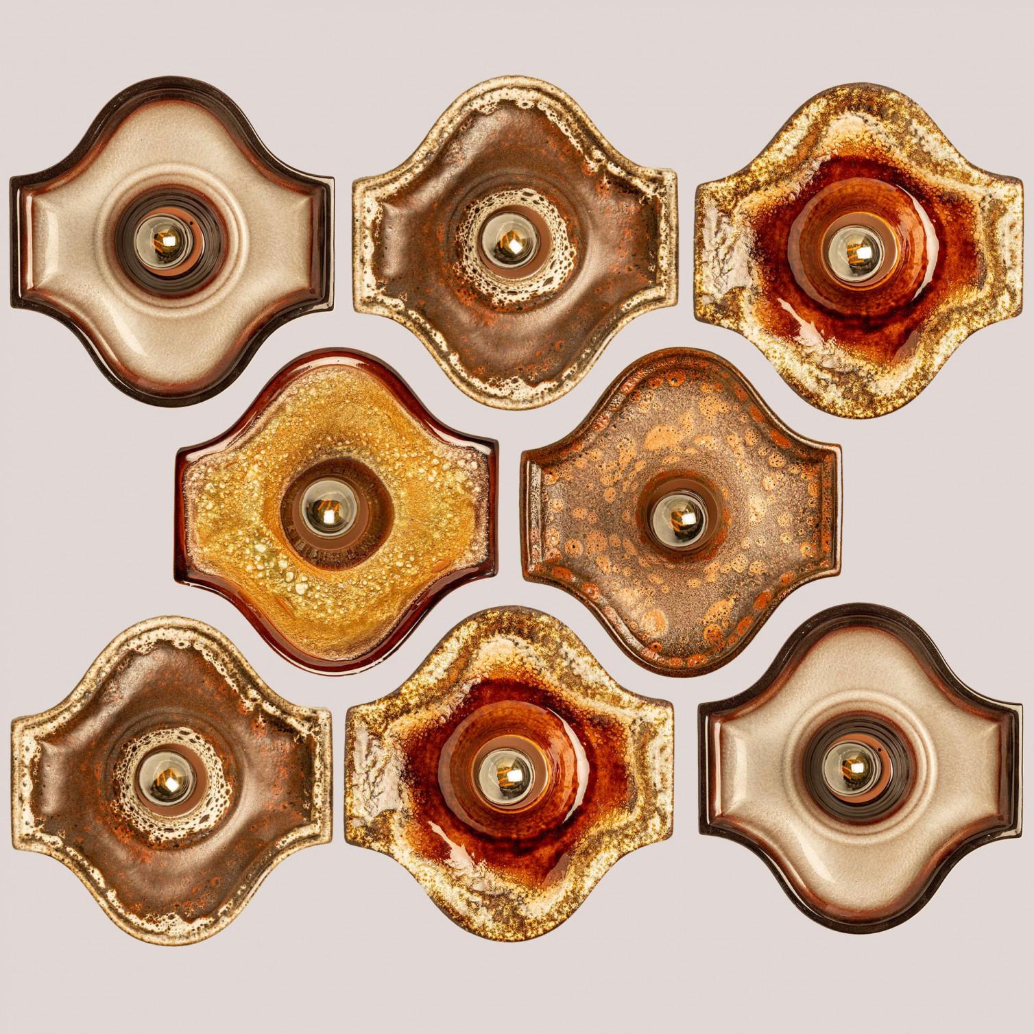 Beautiful set of oval ceramic wall lights in Fat Lava style. Manufactured in Germany around the 1970s.

The glaze has warm color gradients.

We used clear light bulbs (see images), but silver or gold light bulbs are also very