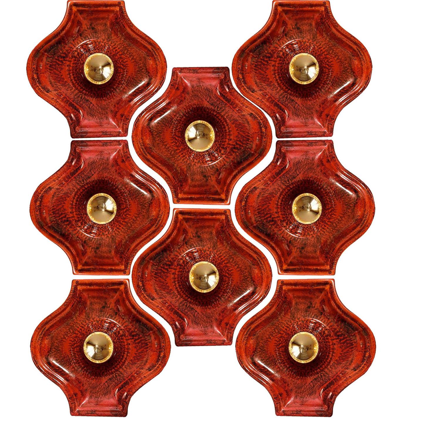 Red ceramic wall lights in Fat Lava style. Manufactured by Hustadt Leuchten Keramik, Germany in the 1970s.

The style of the glaze is called 'Fat Lava'. Which means the glaze is thick on some parts, like lava.
A typical way to finish ceramic in