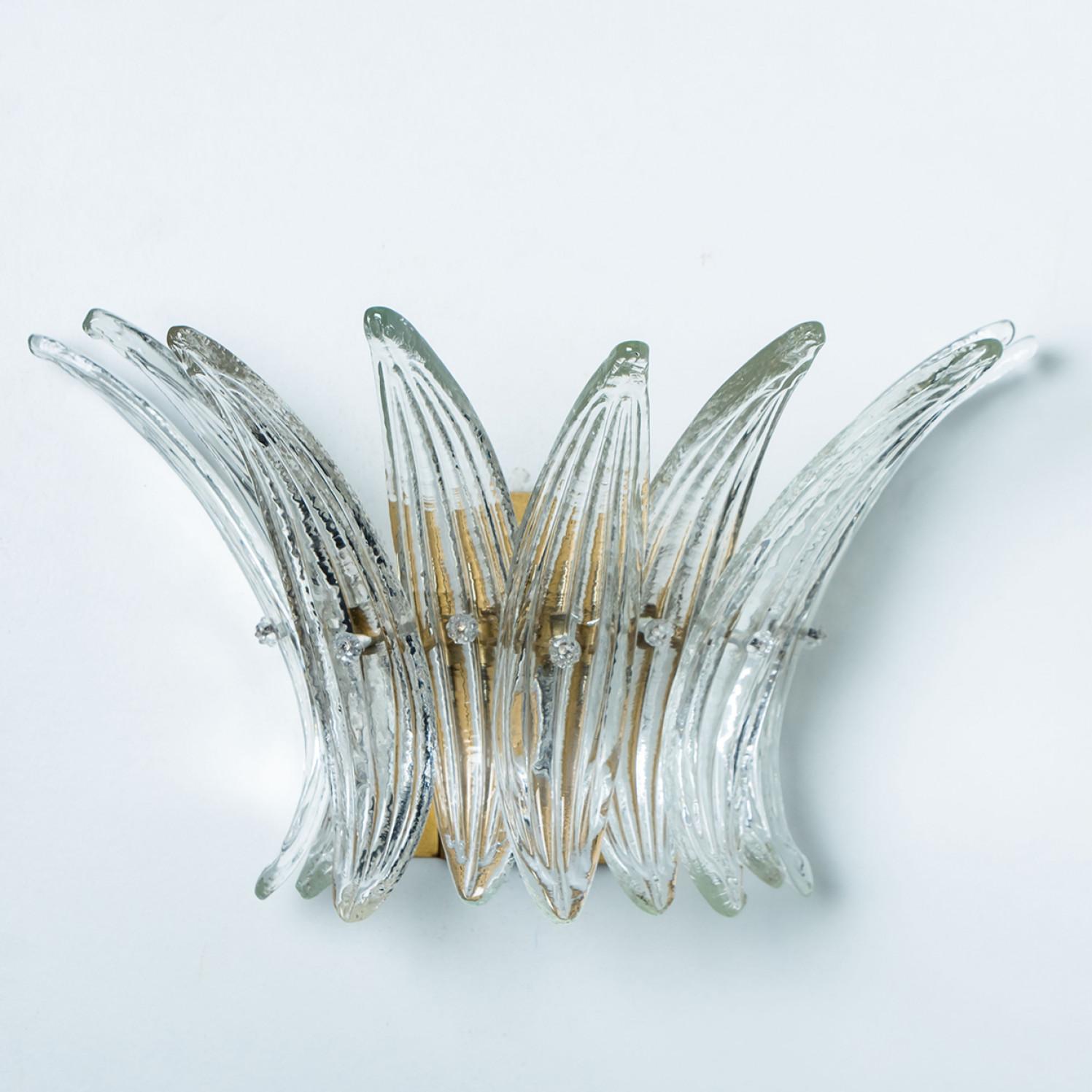 Beautiful wall lights were designed in the style of Kalmar, featuring a brass base and a rectangular glass cover in opal and clear glass. The glass cover consists of one layer of beautiful palm leaves put together to create a 