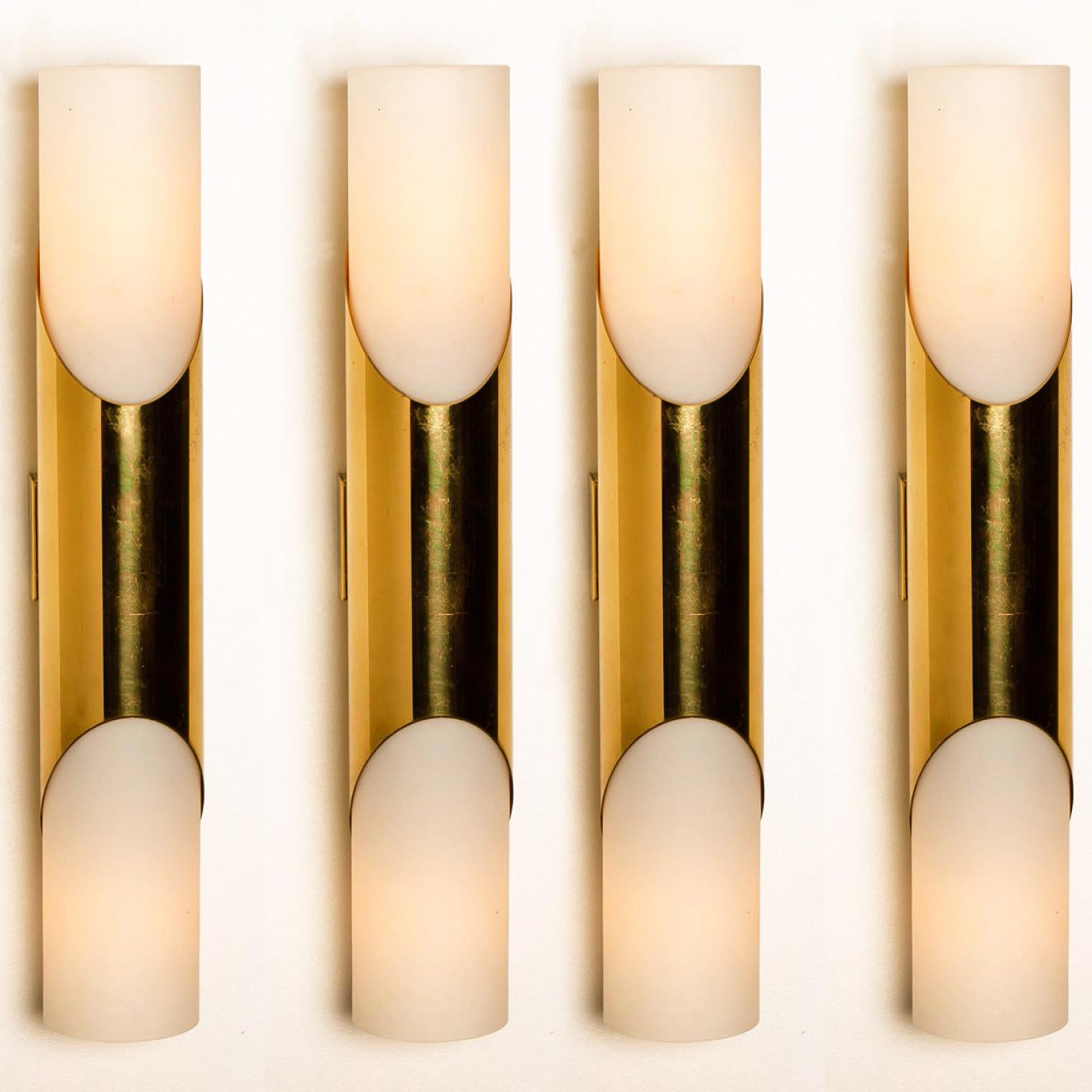 Stunning wall sconces designed in the style of RAAK. Opaline glass with brass details.
Minimalistic design executed with a taste for excellence in craftsmanship.

Good condition that means this piece is not new but in a very good vintage condition