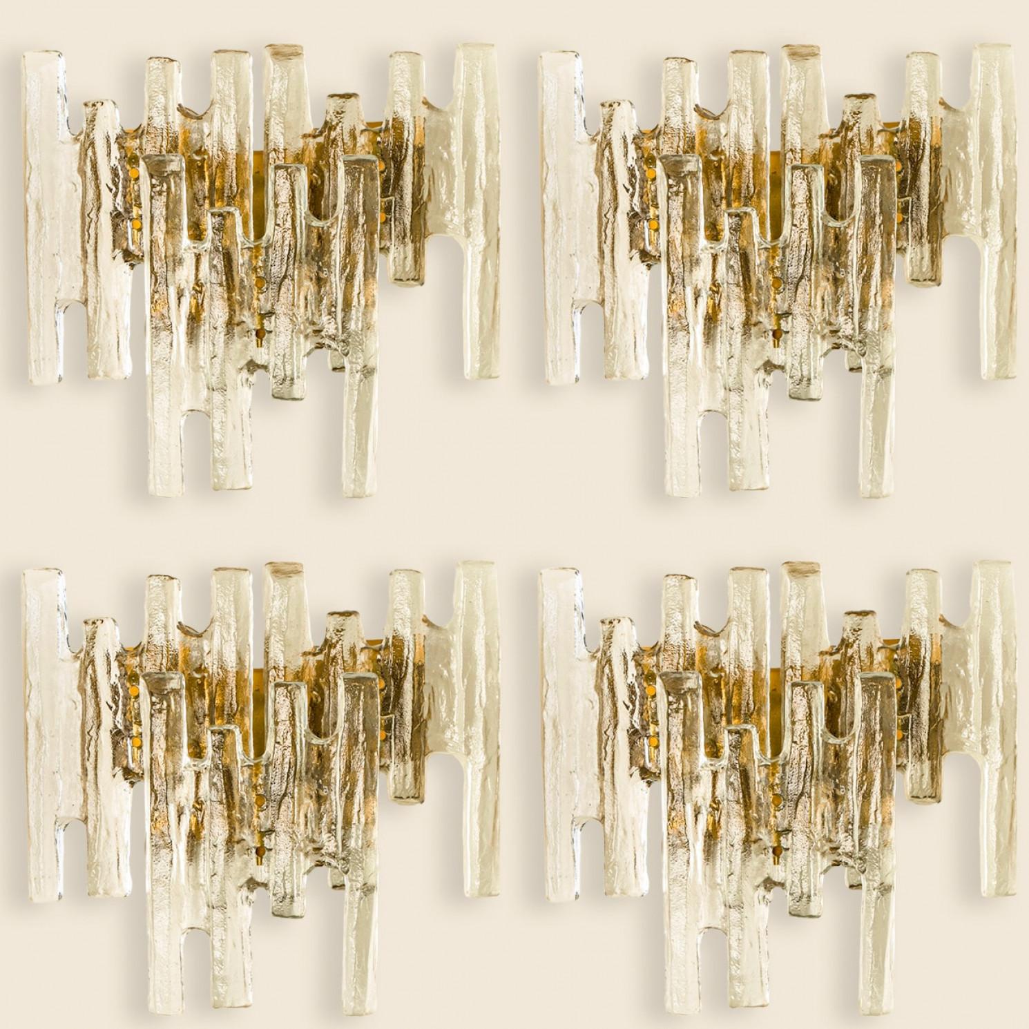 Beautiful high quality light fixture made by Kalmar, Austria. Manufactured in mid century, circa 1970 (at the end of 1960s and beginning of 1970s).

This XL wall light features lights made of handmade ice glass and brass back plate. The sides