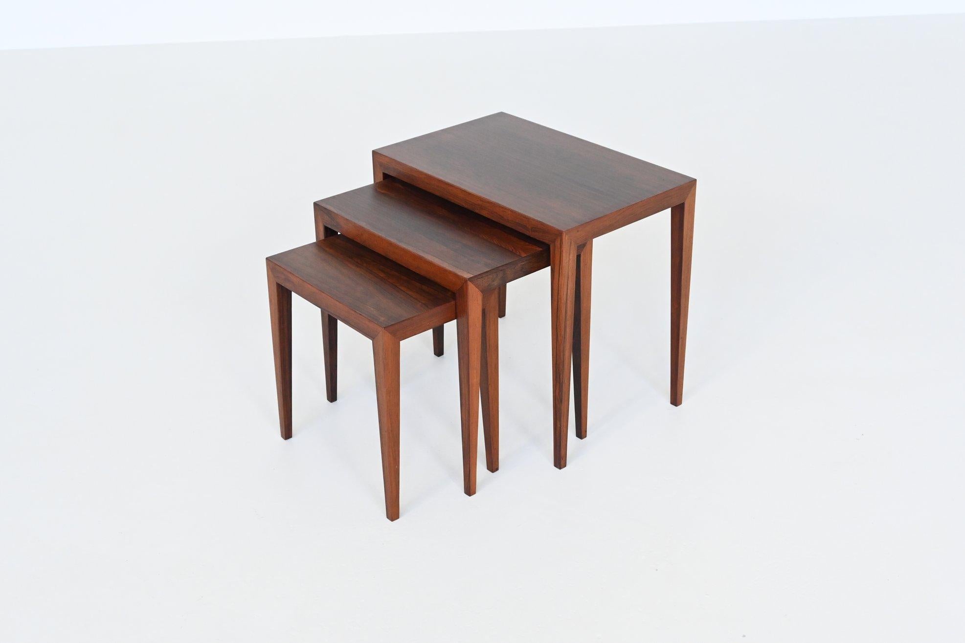 Beautiful shaped set of three nesting tables model 163 designed by renowned Danish designer Severin Hansen Jr. for Haslev Møbelsnedskeri, Denmark 1960. This sophisticated set of nesting tables is made of richly grained rosewood veneer. They boast a