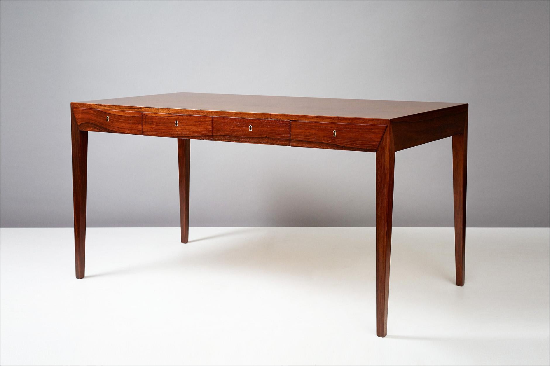 Severin Hansen Jnr.

Writing desk, circa 1950s.

Produced by Haslev Mobelsnedkeri, Denmark. Rosewood veneer construction and brass fittings with 4 integral drawers. Original keys are included. The item has been professionally restored by our