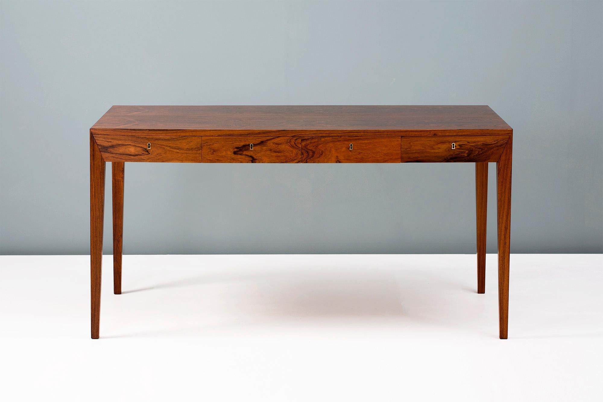 Severin Hansen Jnr.

Writing desk, circa 1950s.

Produced by Haslev Mobelsnedkeri, Denmark. Rosewood veneer construction and brass fittings with 4 integral drawers. Original keys are included. The item has been professionally restored by our
