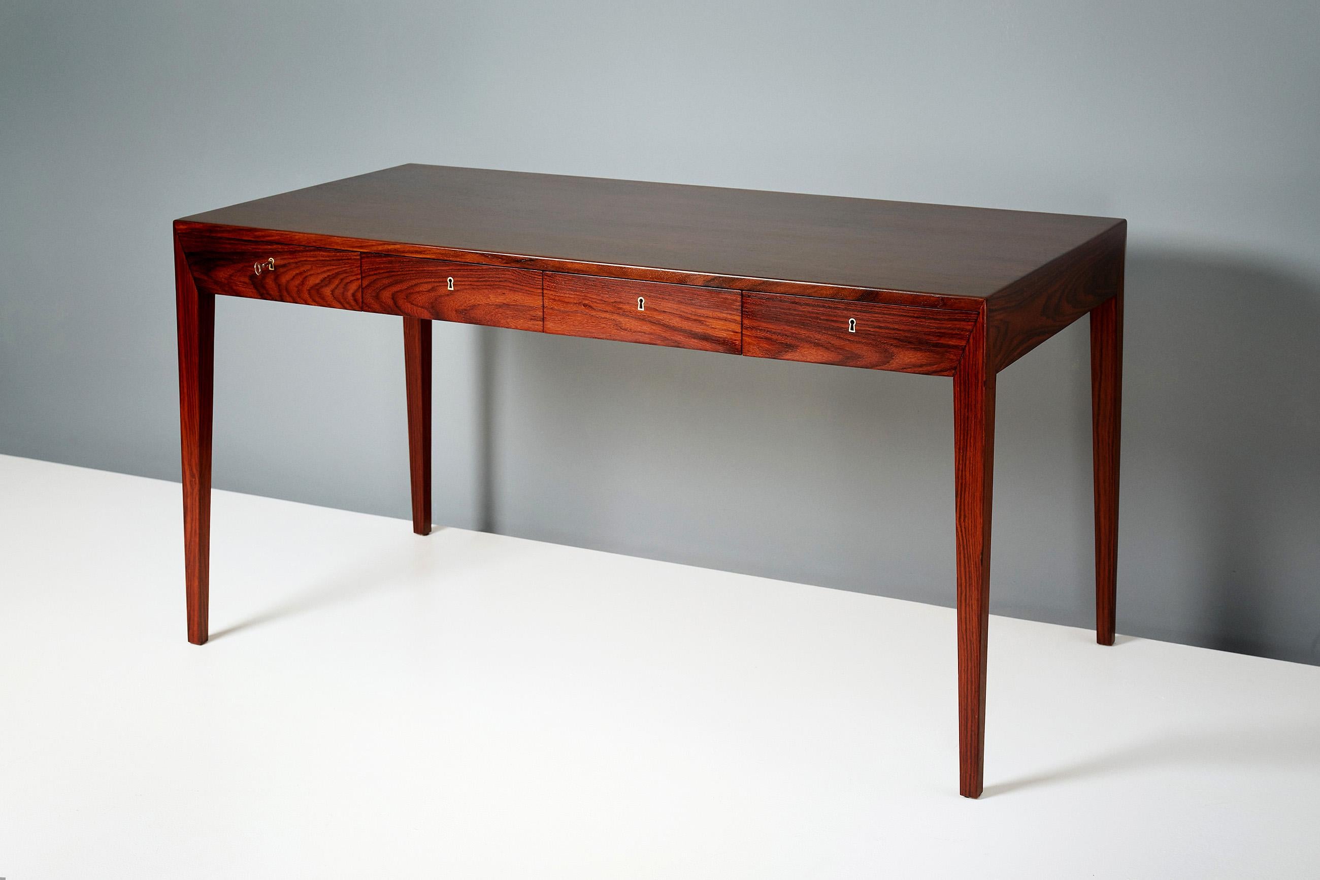 Severin Hansen Jnr.

Writing desk, circa 1950s.

This iconic piece of Danish design was produced by Haslev Mobelsnedkeri in Denmark in the late 1950s. The desk is made from solid and veneered rosewood with brass fittings in 4 integral drawers.