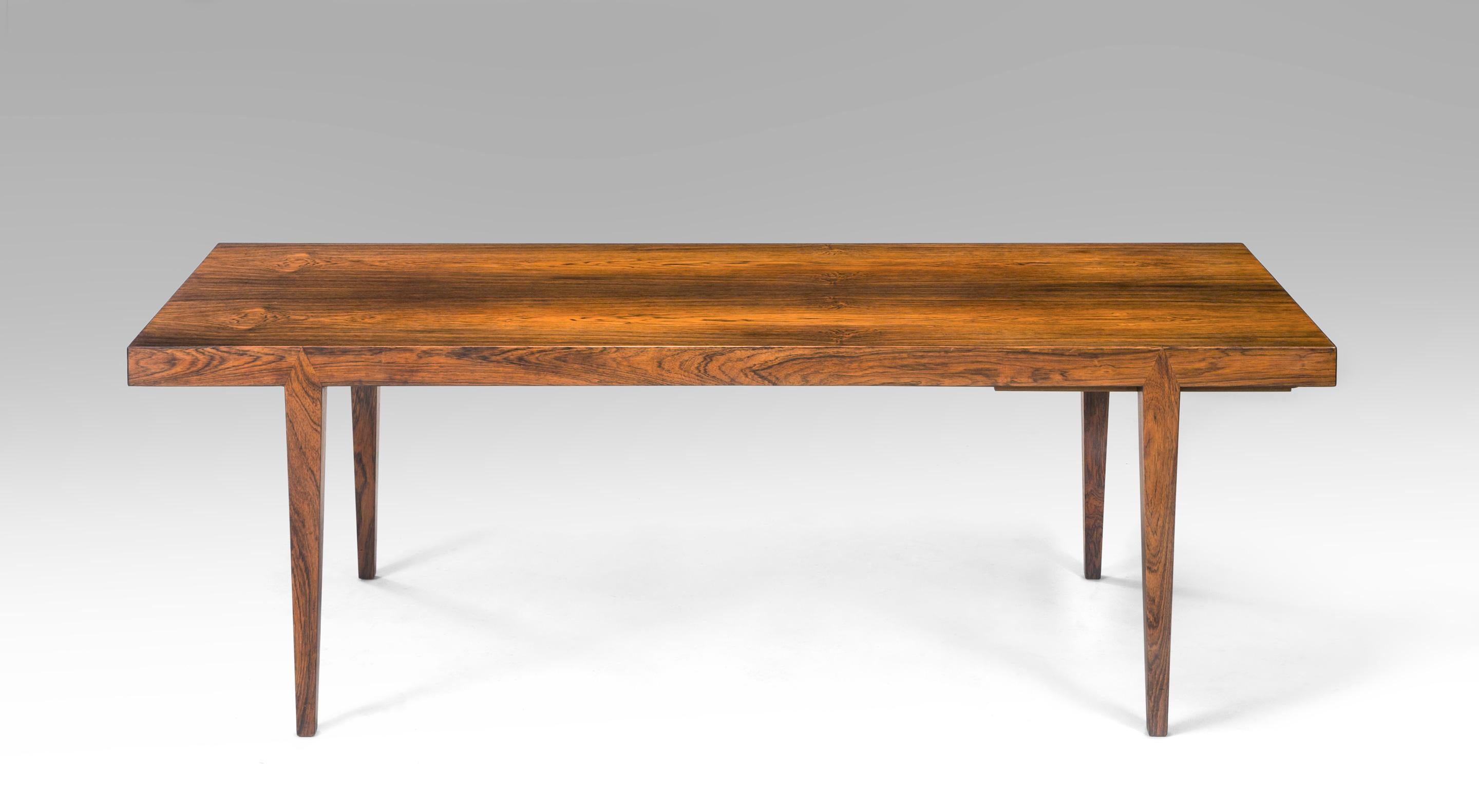 Severin Hansen, a Danish rosewood coffee table
mid-20th century
The richly figured rosewood veneered top is drop dead beautiful and raises this coffee table into the superlative category. The rectangular bookmatched top above a concealed rectangular