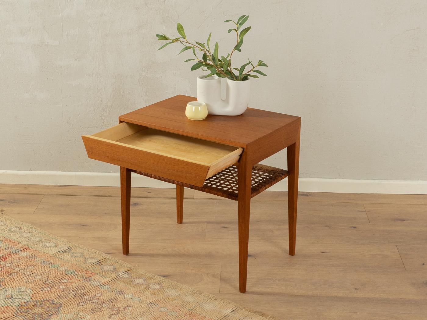 Rare bedside table designed by Severin Hansen for Haslev Møbelsnedkeri from the 1950s. High-quality corpus in teak veneer with one drawer, one shelf made of original rattan wickerwork and tapered feet.

Quality Features:
    accomplished design: