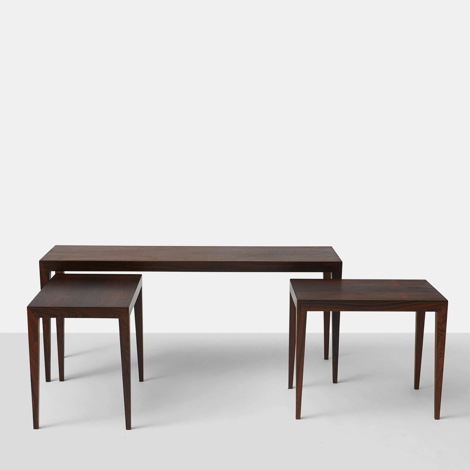 A set of three rosewood nesting tables of rosewood with stiletto legs. Marked for Haslev.