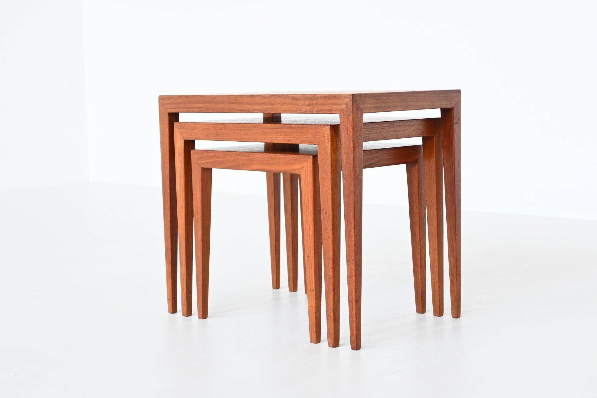 Beautiful shaped set of three nesting tables model 163 designed by Severin Hansen Jr. for Haslev Møbelsnedskeri, Denmark 1960. This sophisticated set of nesting tables is made of nice grained teak veneer. They give a minimalist look due to the