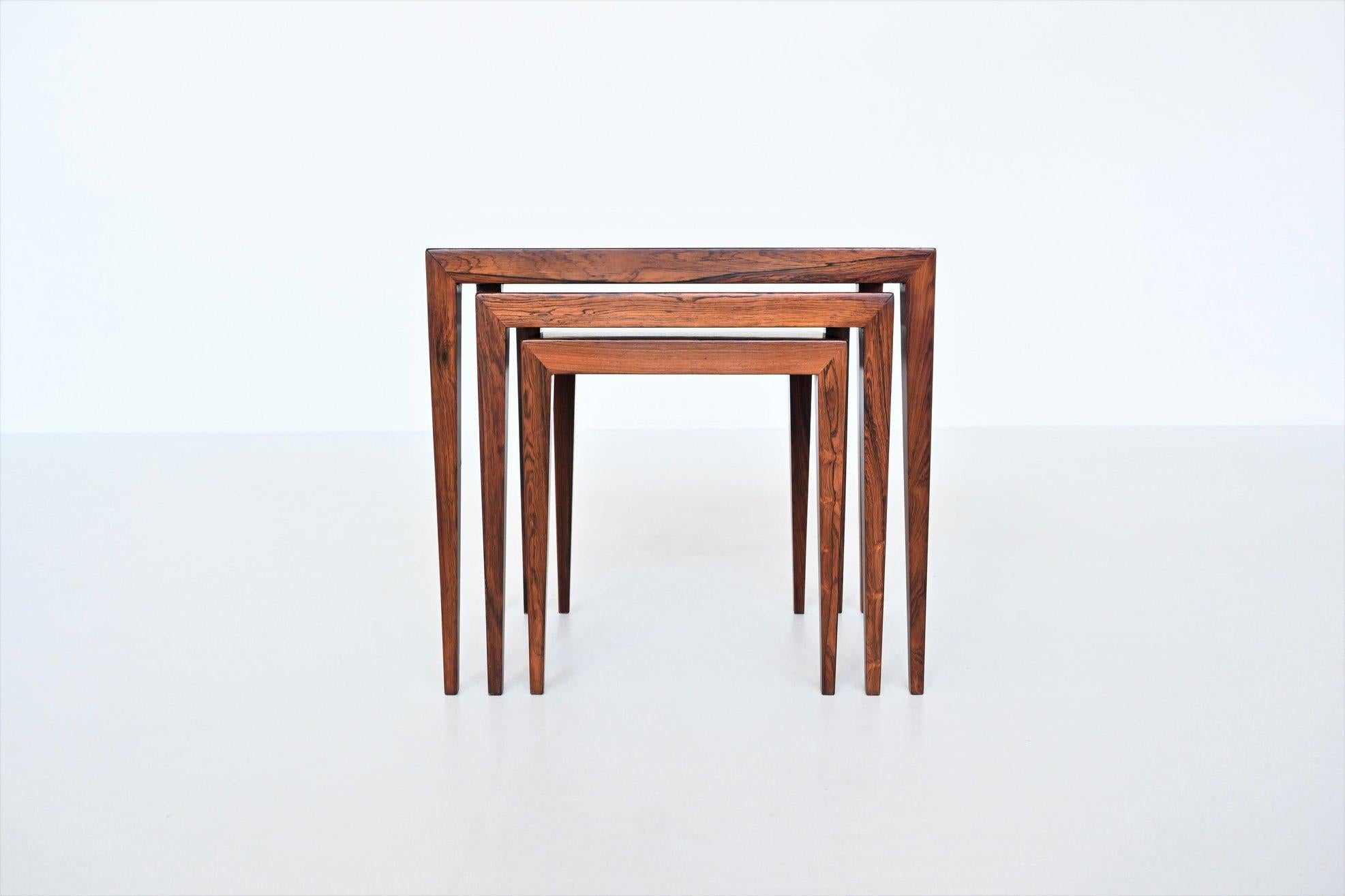 Beautiful shaped set of three nesting tables model 163 designed by Severin Hansen Jr. for Haslev Møbelsnedskeri, Denmark 1960. This sophisticated set of nesting tables is made of nice grained rosewood veneer. They give a minimalist look due to the