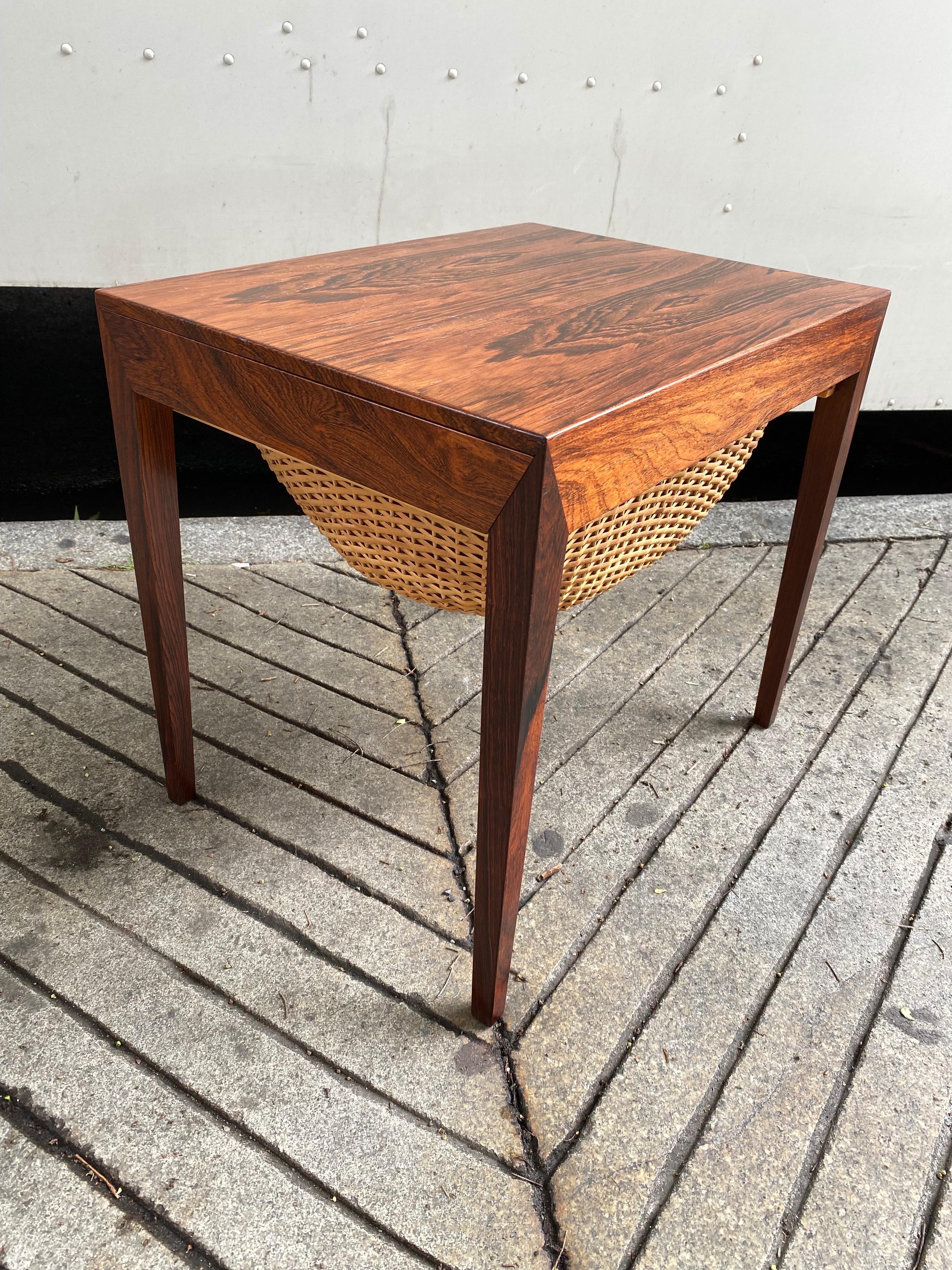 Severin Hansen rosewood sewing table/ side table. Beautiful condition, top refinished and all cleaned and finished. One pull out drawer and one hanging basket. Can be used as a side table very easily! Basket is perfect for magazines, knitting etc!