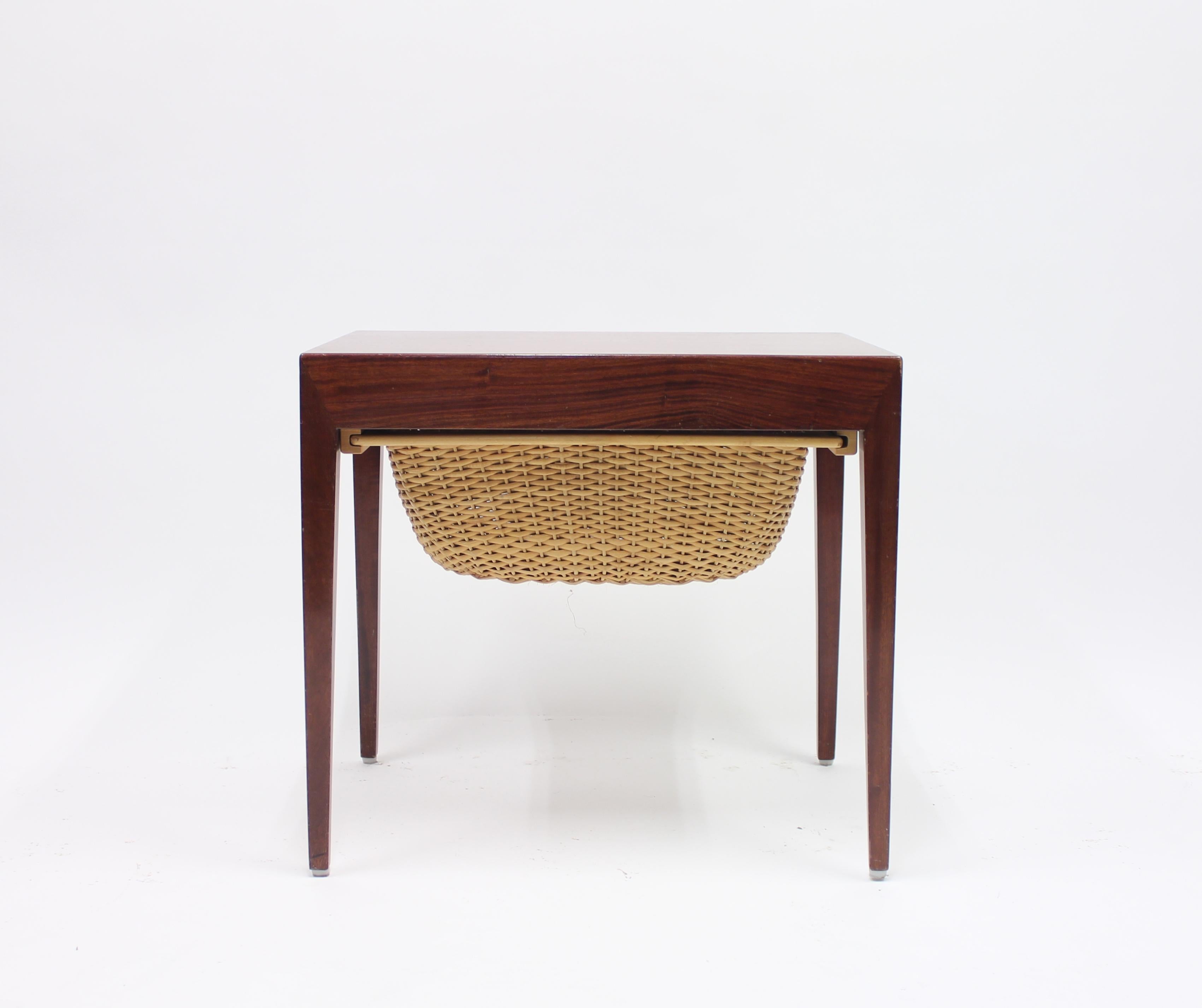 1950s rosewood sewing- or side table with rattan basket by Danish designer Severin Hansen for Haslev Møbelsnedkeri. Marked with Danish Furniture makers Control mark. Good condition with ware consistent with age and use.