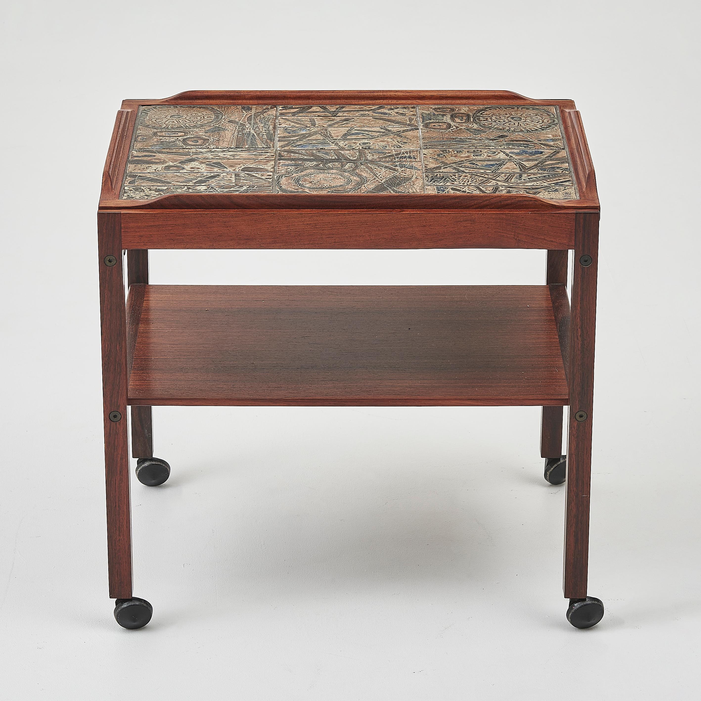 A rare Rosewood side table by Severin Hansen featuring Royal Copenhagen tiles. 


This side table has a ceramic tiled top design, the top can be removed and used as a tray, the table is set on castors allowing it to be easily moved around. It is a