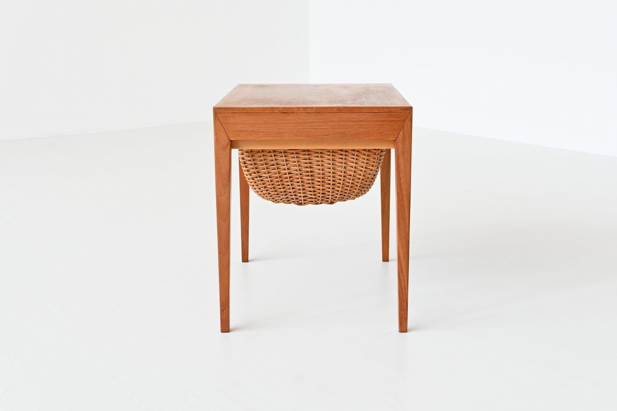 Beautiful sewing table designed by Severin Hansen, manufactured by Haslev Møbelsnedskeri and distributed and sold by Bovenkamp Furniture, Denmark 1960. This table is made of high quality teak wood with underneath the top a wicker basket for wool and