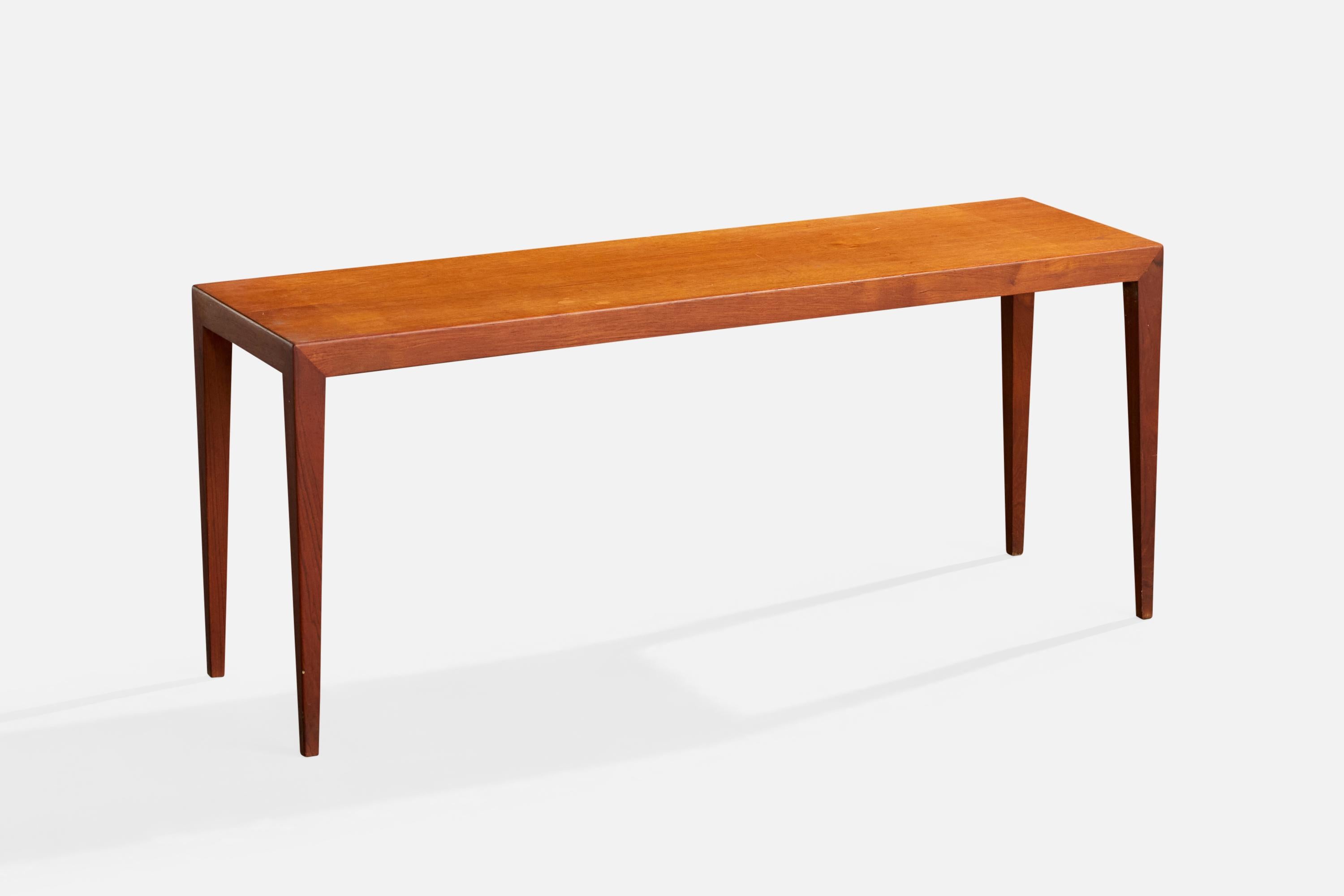 A teak side table or low console table designed by Severin Hansen and produced by Haslev, Denmark, c. 1950s

Minor imperfections in wood tabletop surface and scuffs on legs.

Overall Dimensions (inches): 18.5