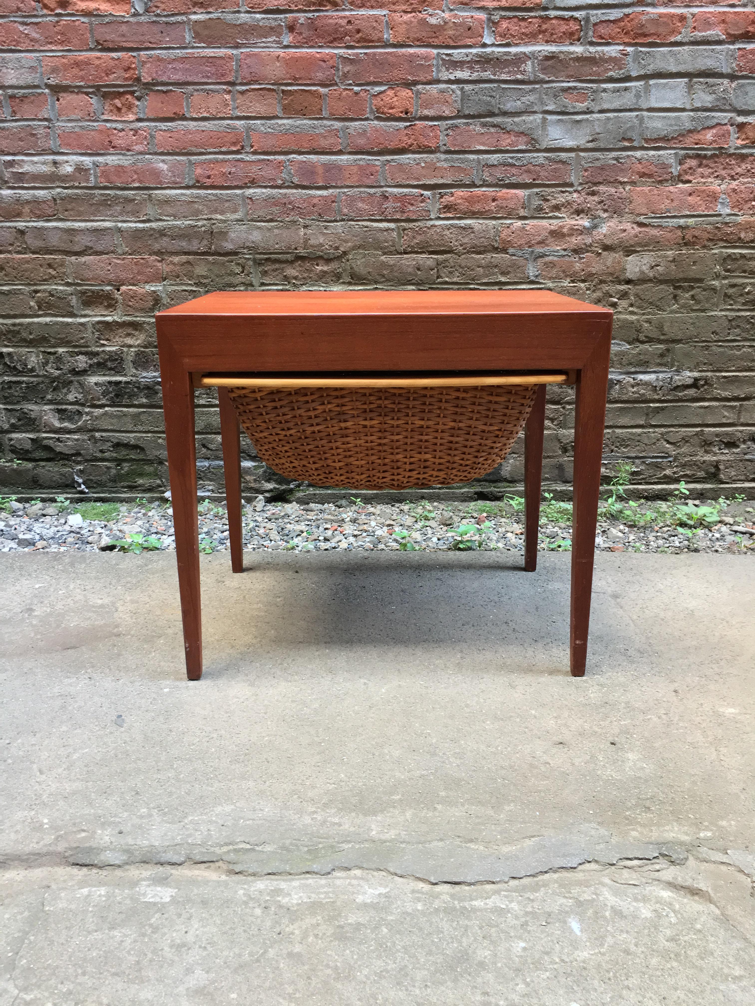 Teak and rattan sewing table designed by Severin Hansen Jr. for Haslev Mobelsnedkeri, circa 1960. Tapered legs, rattan basket and a small drawer originally for sewing implements complete with pin cushion! The rattan basket initially held yarn,
