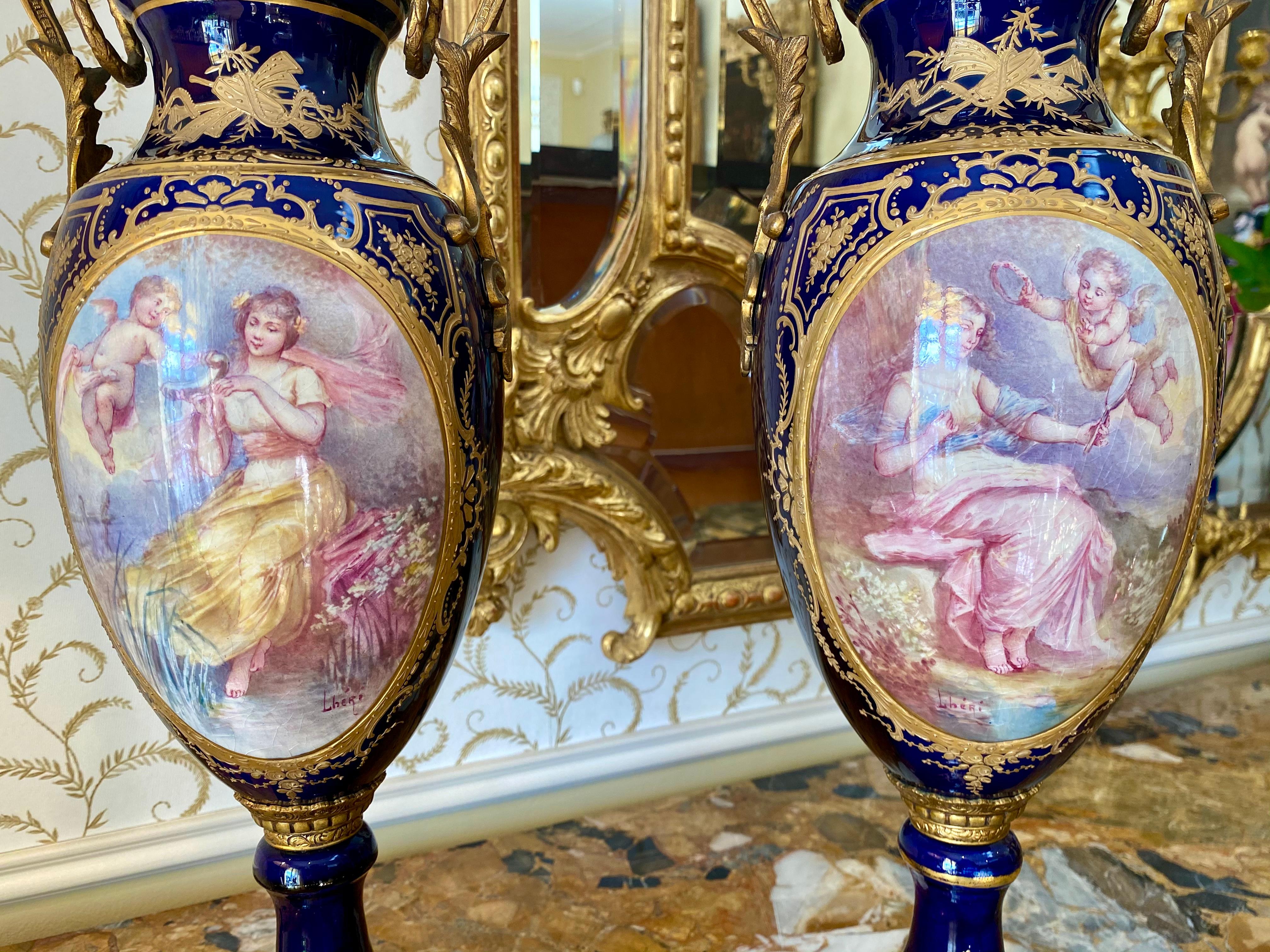 Superb pair of cobalt blue Sevres porcelain vases, decorated on one side with romantic scenes signed 